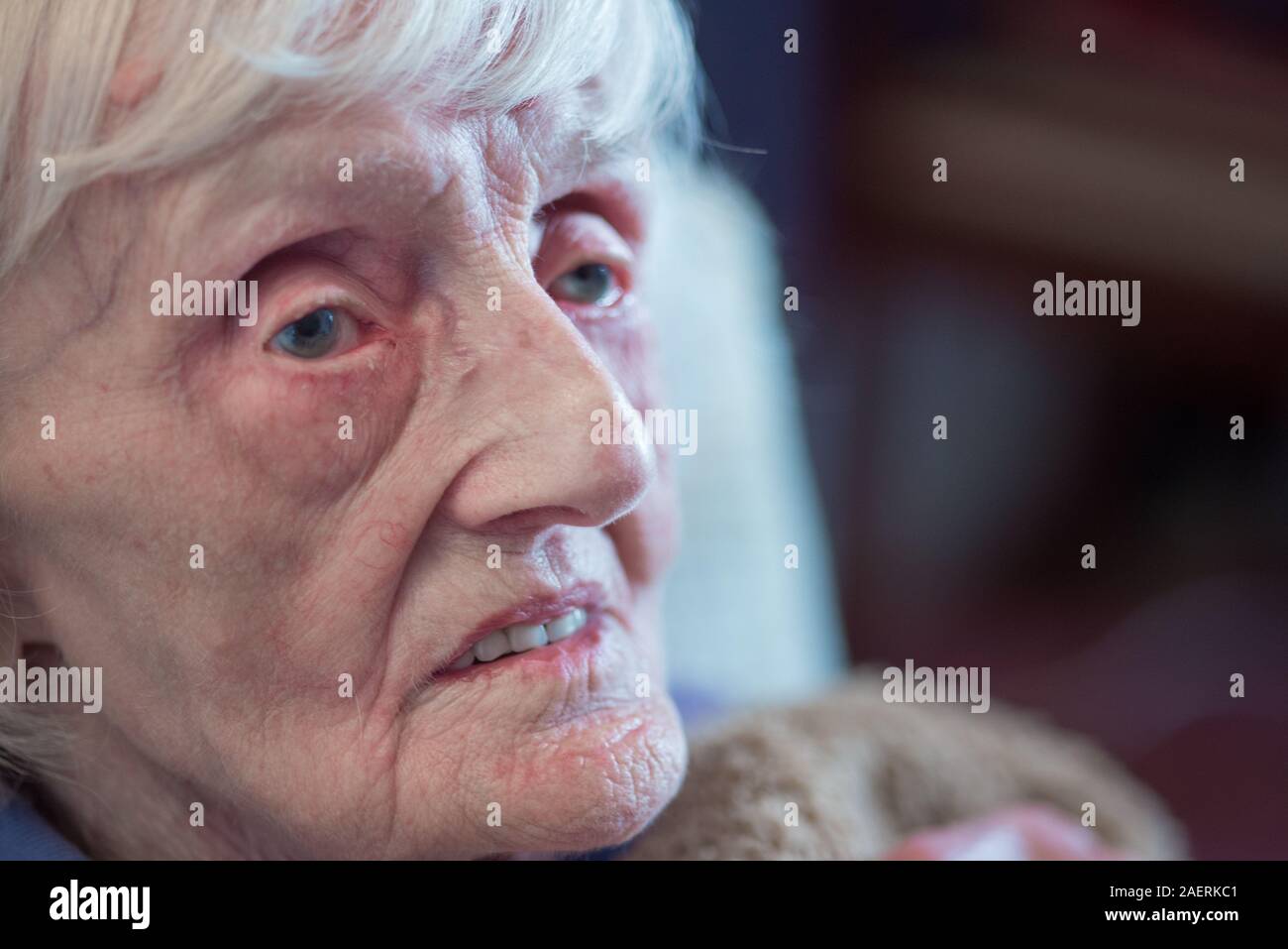 The ninety year old lady is covered in an insulating blanket to try and stay warm and is unable to leave her house unaided as she is registered blind Stock Photo