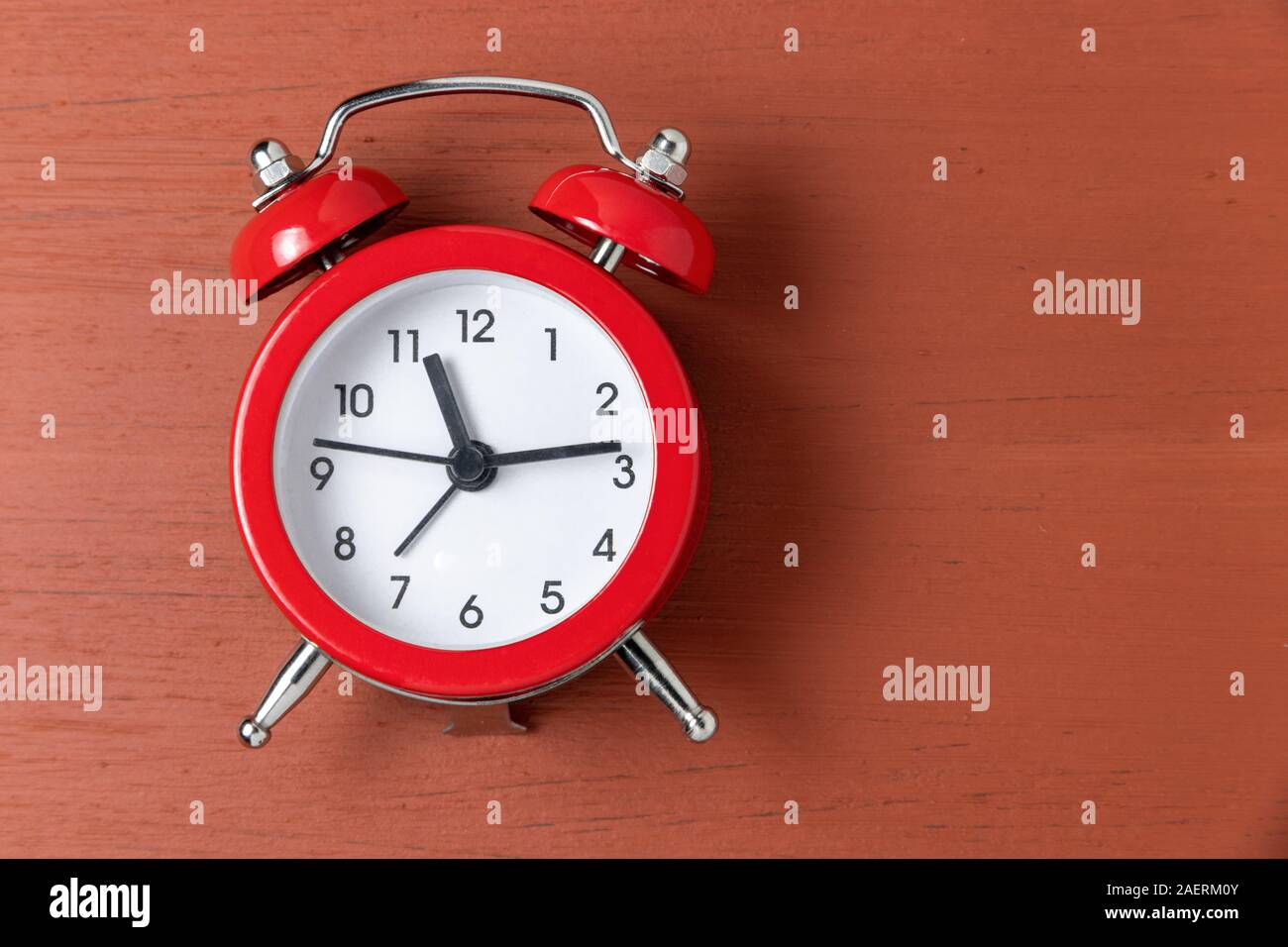 Classic alarm clock on wooden background Stock Photo - Alamy
