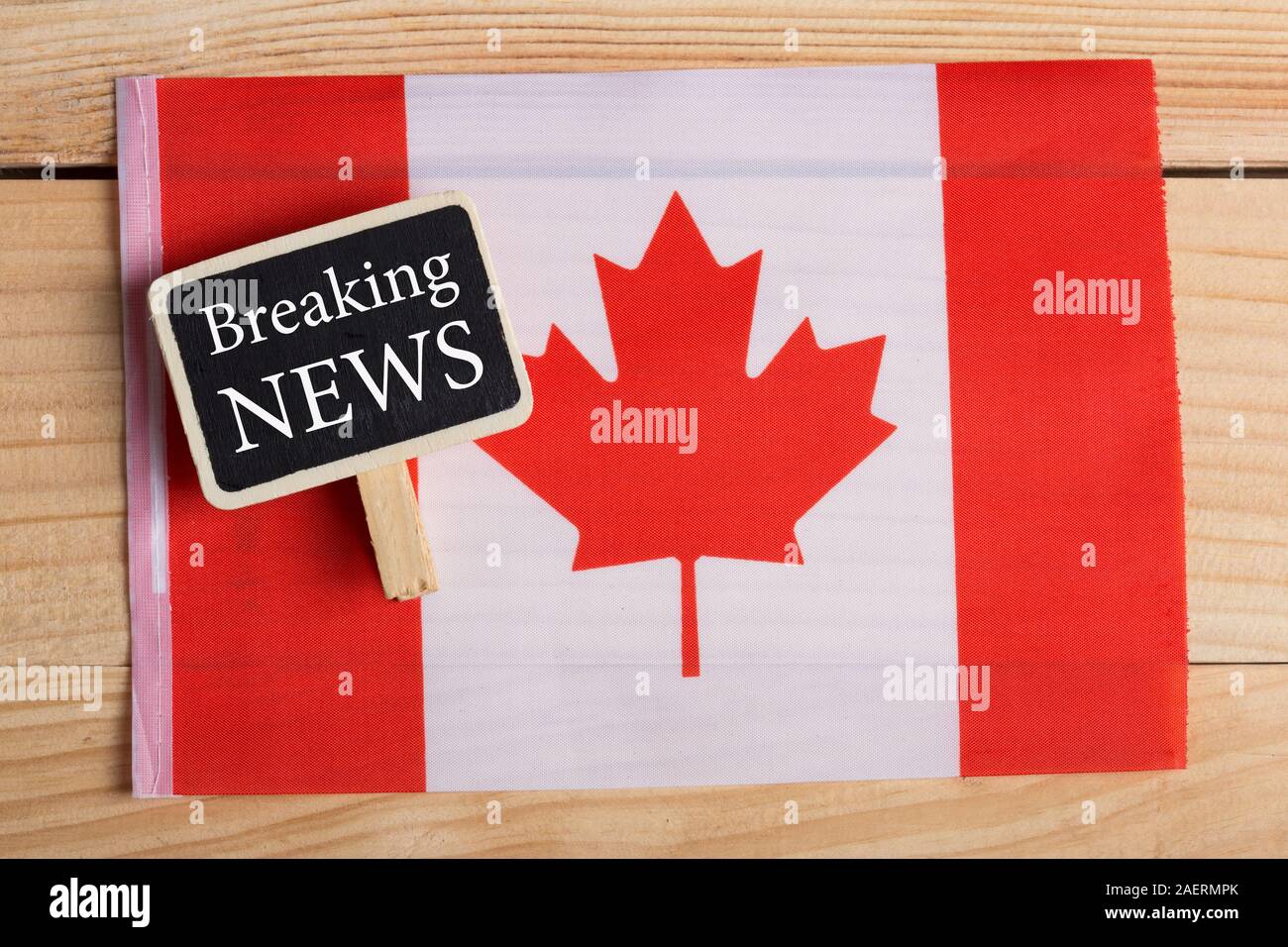 concept news feeds - Latest news, Canadian country's flag, blackboard with text Breaking News on wooden background Stock Photo