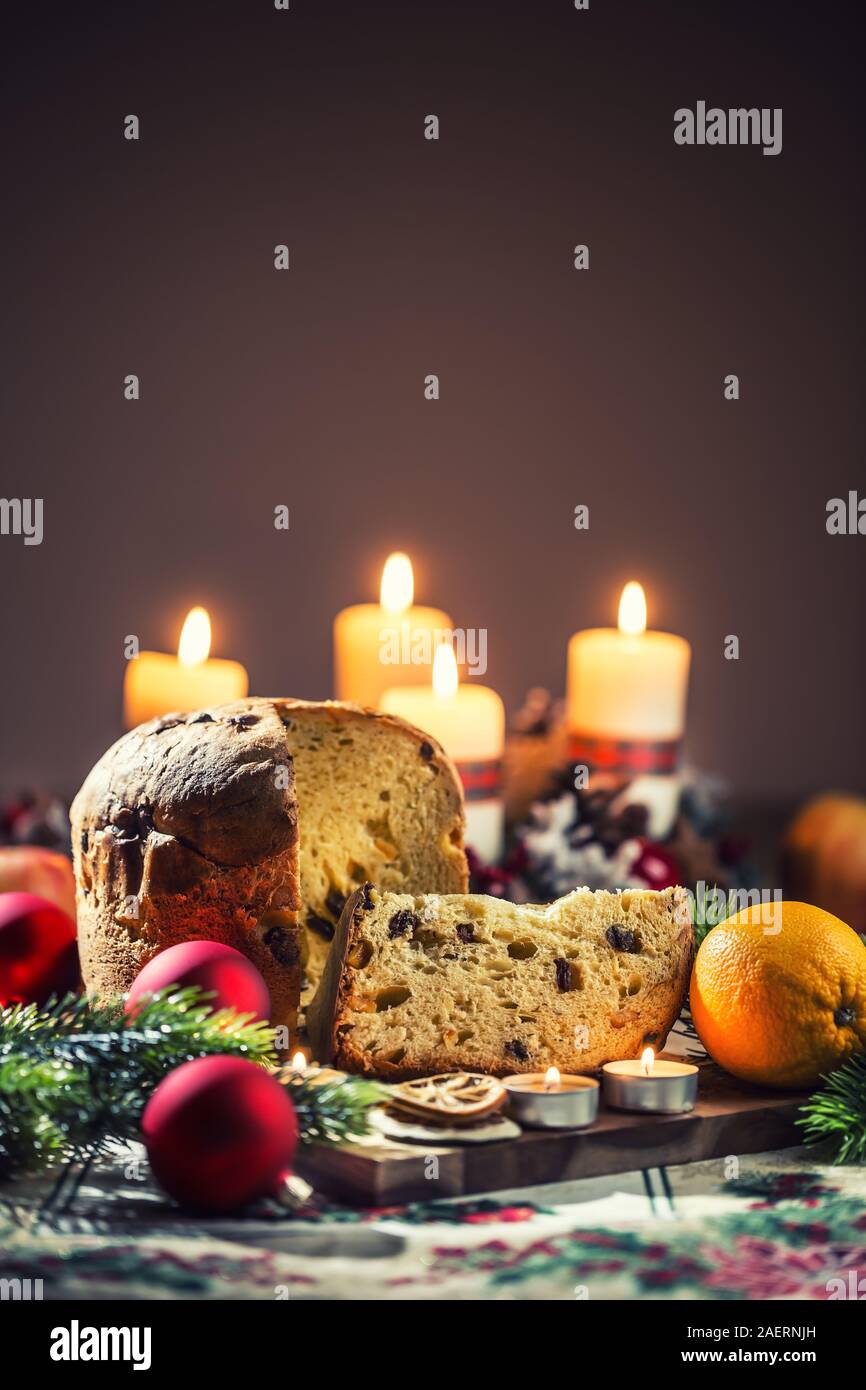 Delicious panettone on christmas table wit decorations and advent wreath and candles. Stock Photo