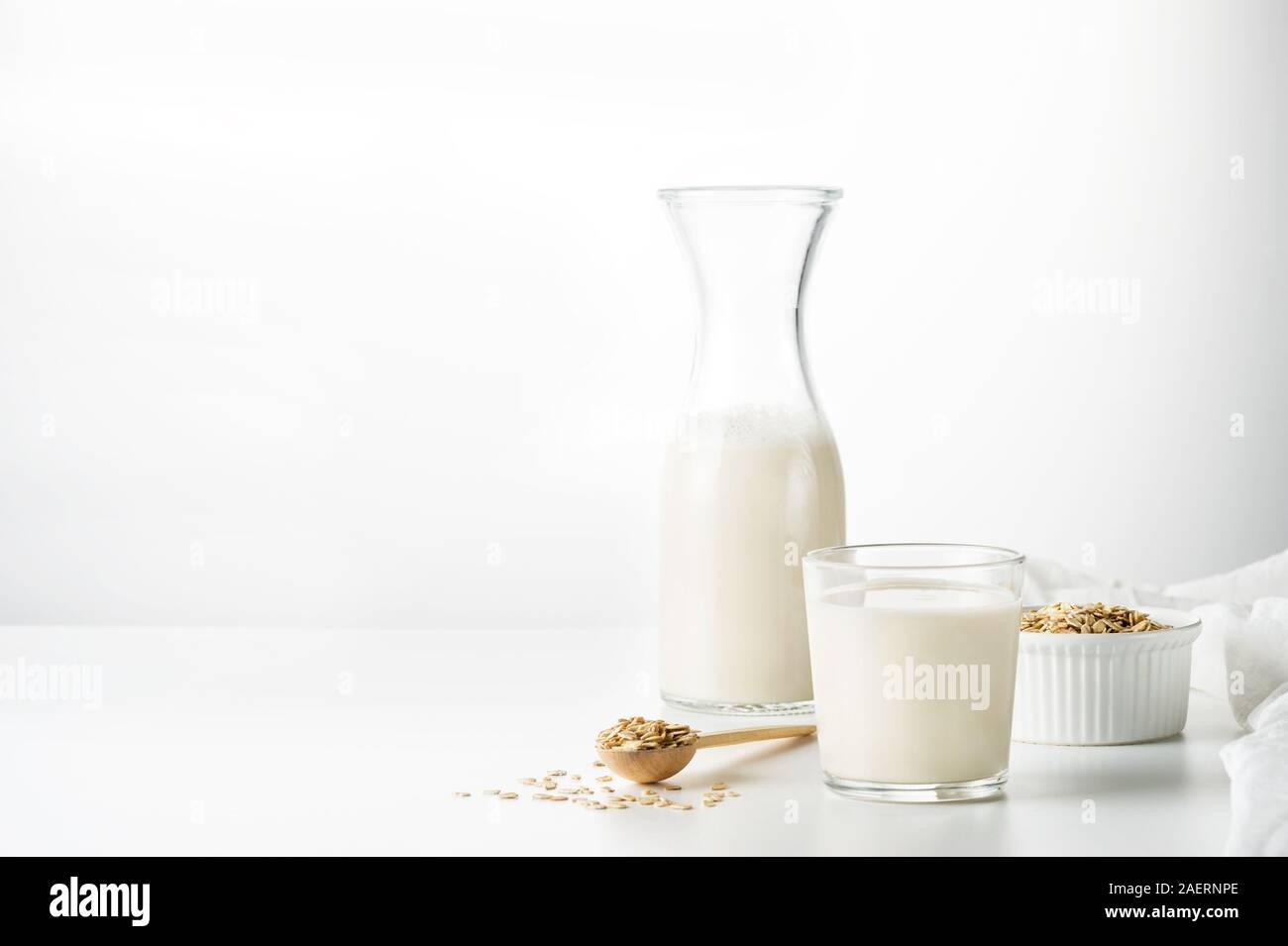 Healthy milk prepared from oats and water blended together, then strained to create a smooth, creamy liquid. Non diary. Vegetarian diet concept. Stock Photo