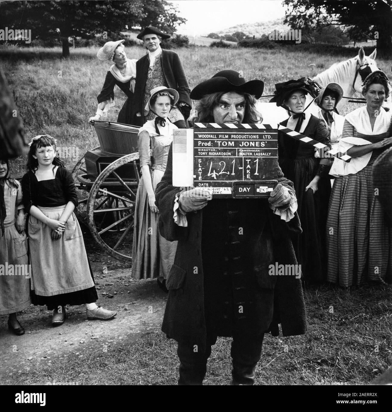 GEORGE DEVINE as Squire Allworthy (in cart) and HUGH GRIFFITH as Squire Western (holding clapperboard) on set candid on location filming TOM JONES 1963 director Tony Richardson screenplay John Osborne novel Henry Fielding Woodfall Film Productions / United Artists Stock Photo