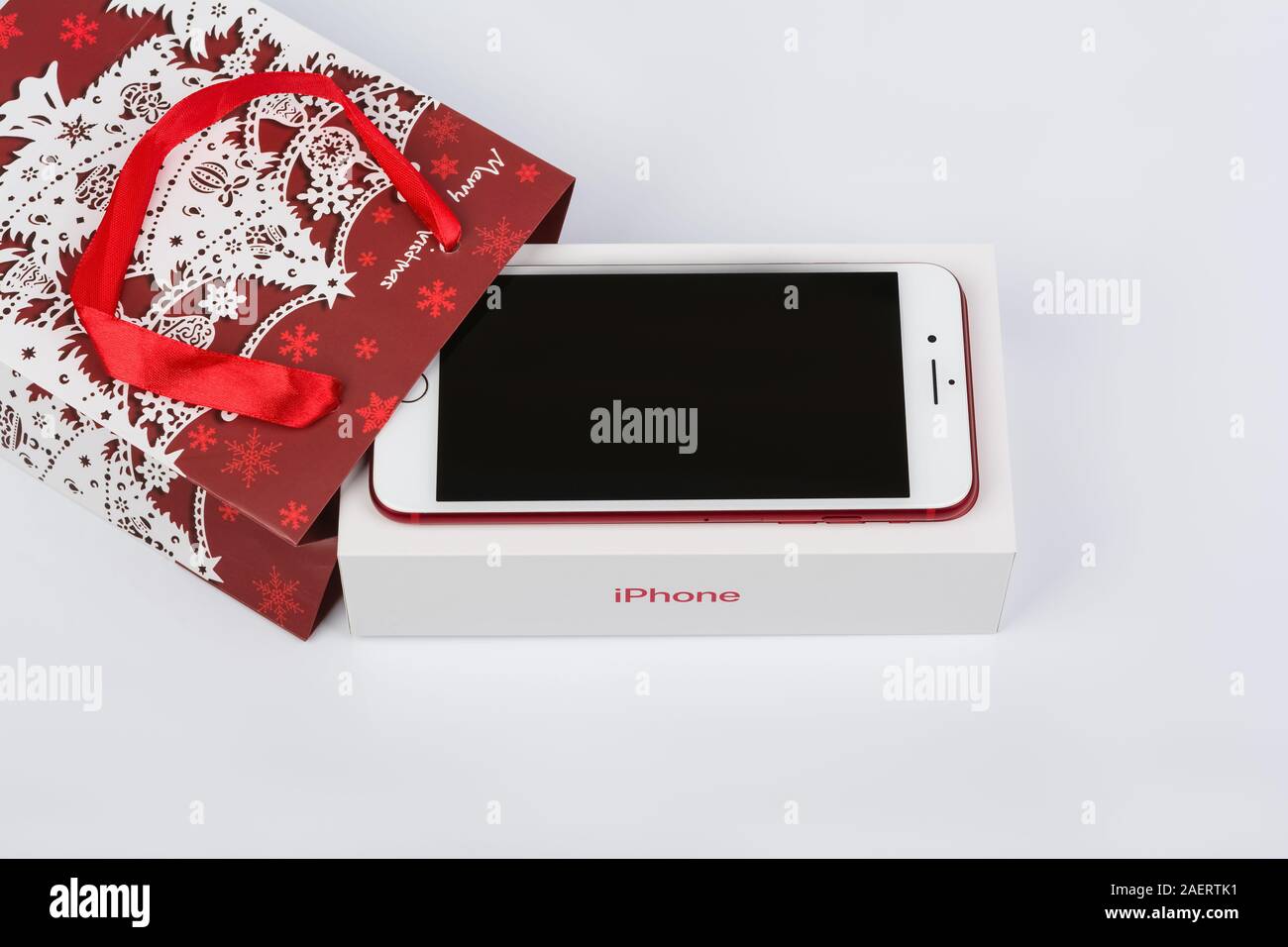 BURGAS, BULGARIA - DECEMBER 10, 2019: Apple iPhone 7 Plus Red Special Edition on white background, front side. Christmas gift. Stock Photo