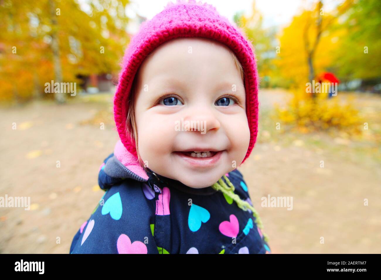 Portrait of little smiling baby girl outdoors Stock Photo - Alamy