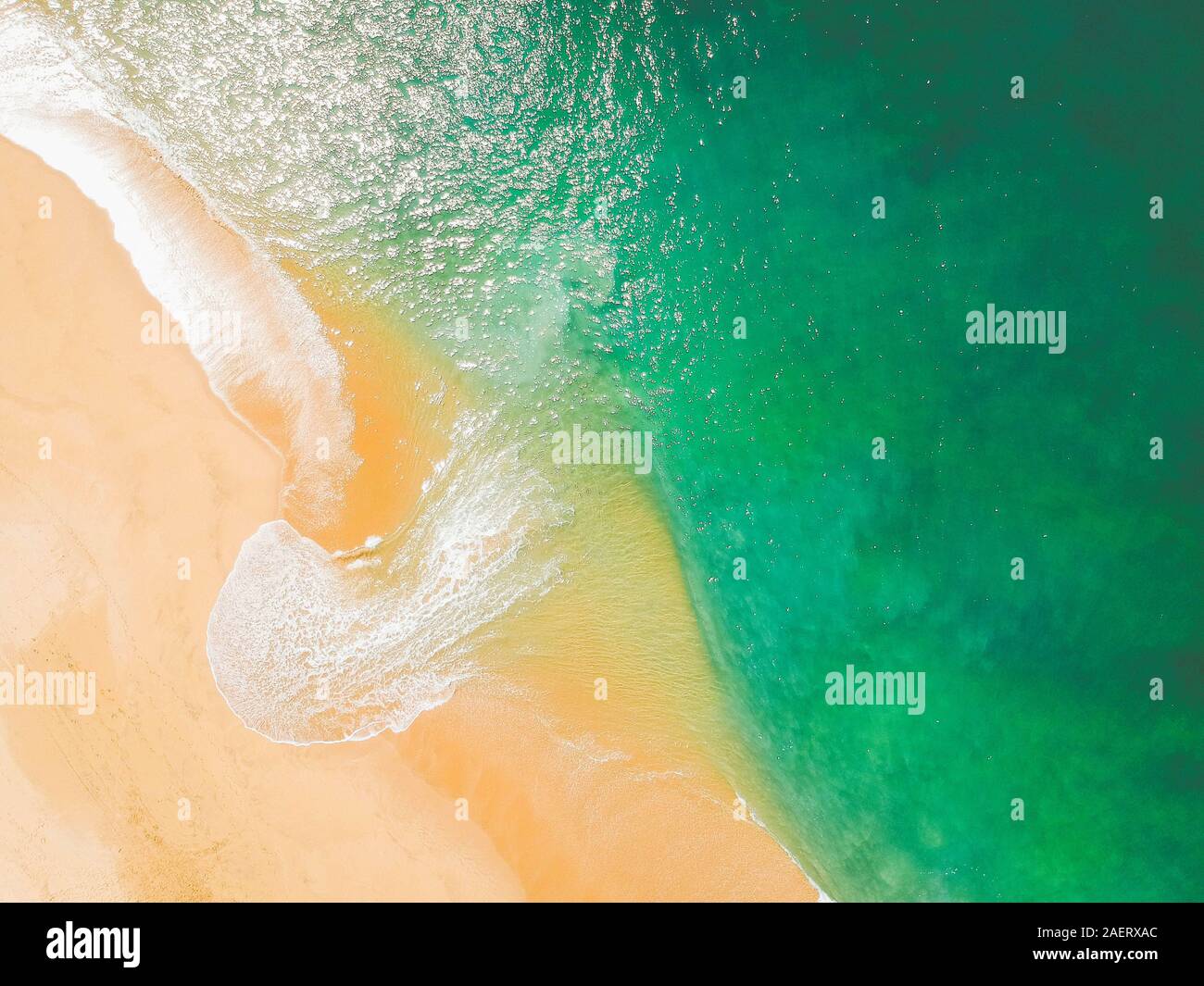Aerial Drone Shot of ocean and sandy beach Green Torquoise Stock Photo