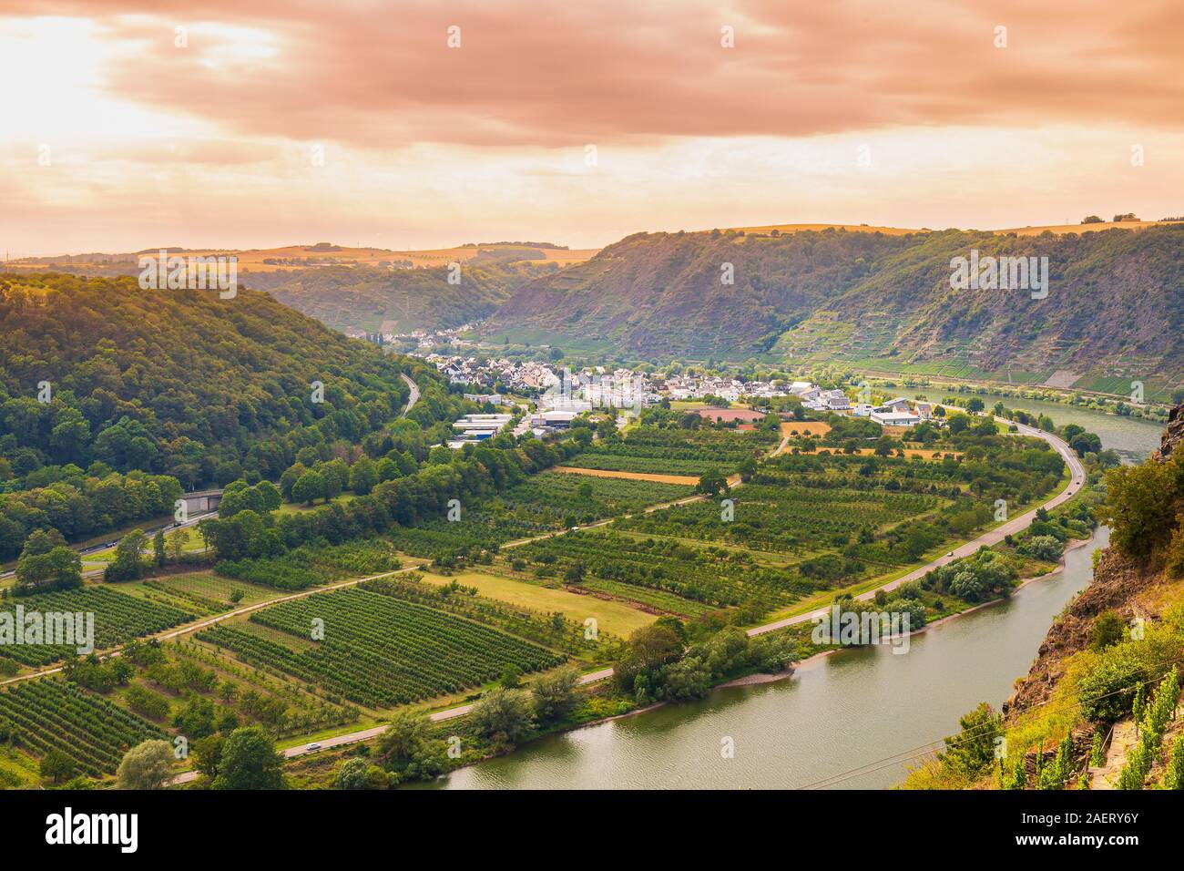 View at a steel beam bridge connecting the Hunsrück and Eifel mountain ranges looking over the Moselle river and Winningen vineyards wine region. Stock Photo