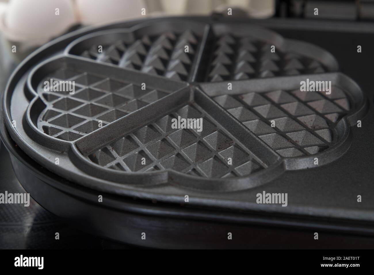 A black waffle iron for heart-shaped waffles Stock Photo