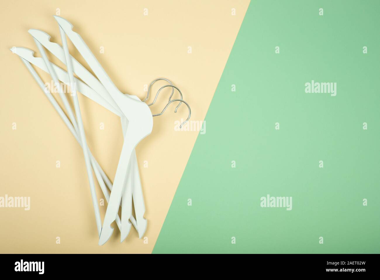 White wooden clothes hanger on colorfull background Stock Photo