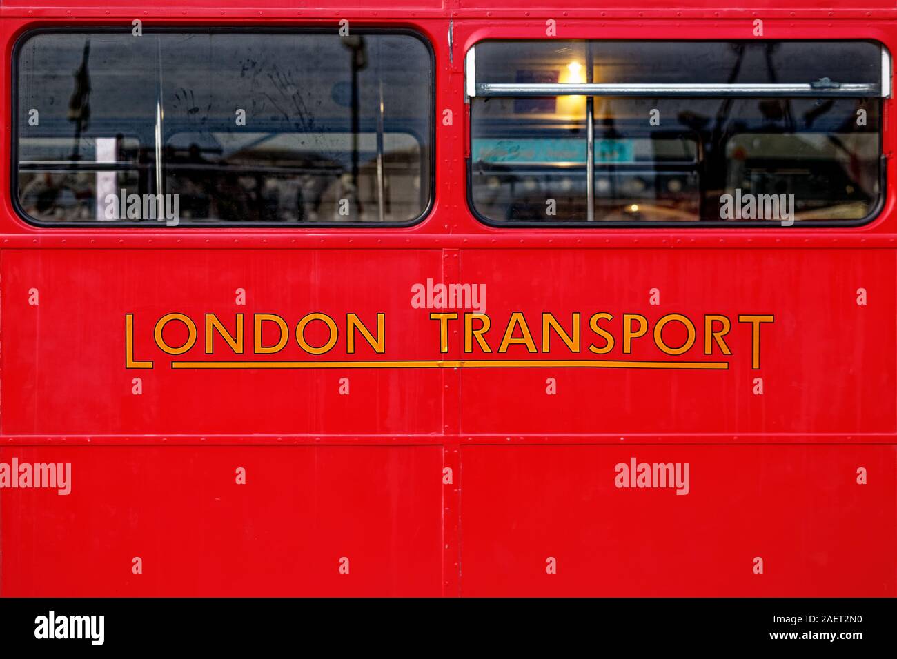 Yellow Colored London Transport Text Written Below Windows Of A