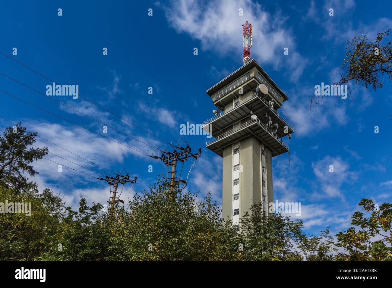 Zelena hora, Pelhrimov / Czech Republic - September 13 2019: Television communication tower, a tall grey building. Sunny day, blue sky and clouds. Stock Photo