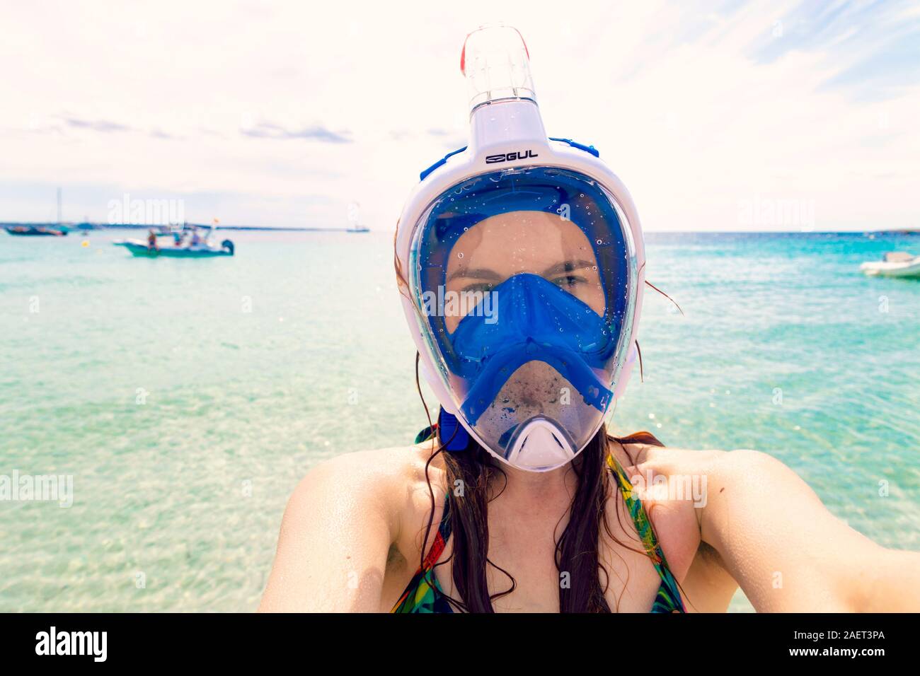 Woman with snorkeling mask on with azure blue sea water in the background, exotic island, S'Espalmador, Formentera, Spain Stock Photo
