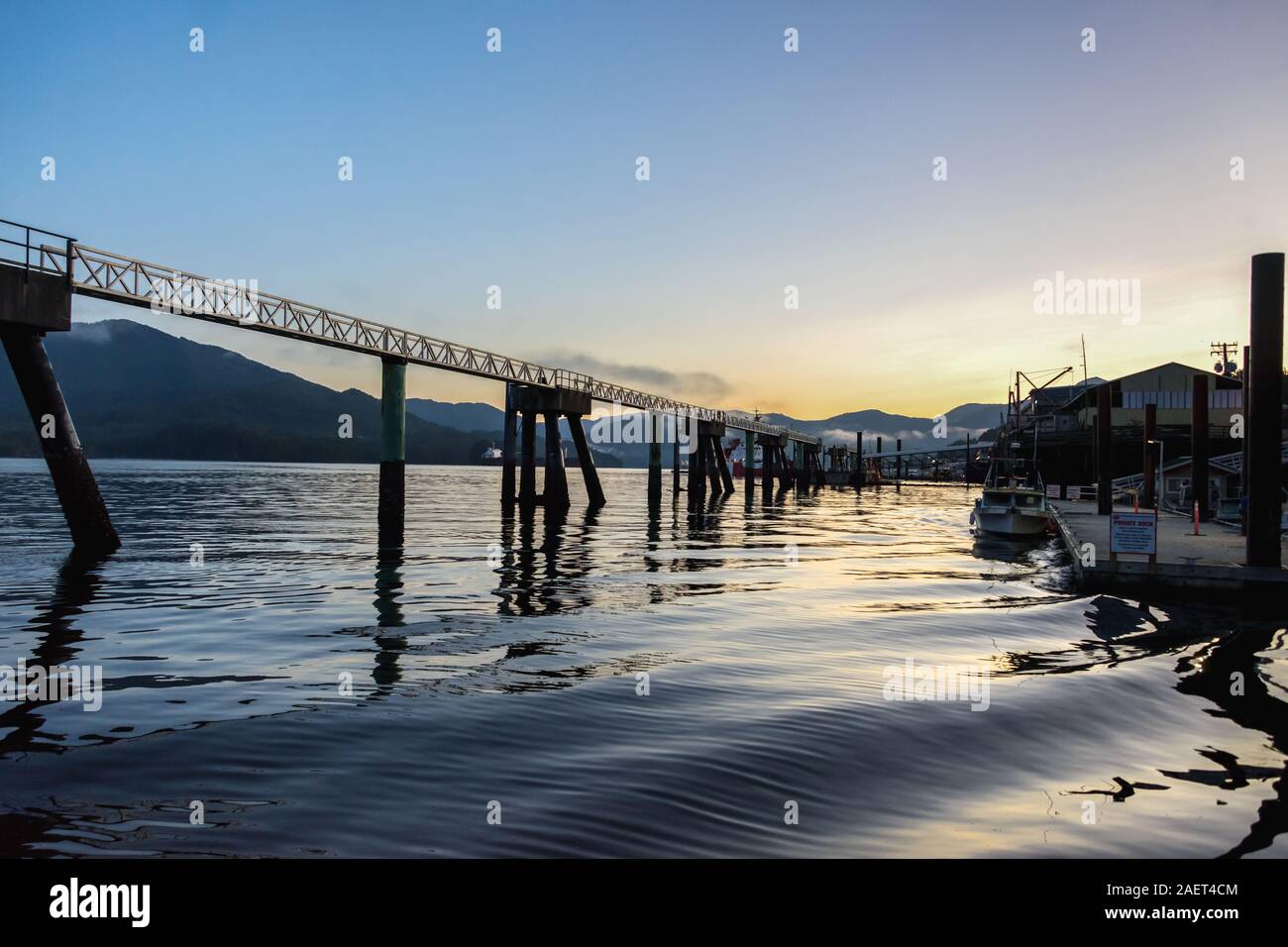 Silhouettes and ripples at sunrise, Prince Rupert Harbour, British Columbia Stock Photo