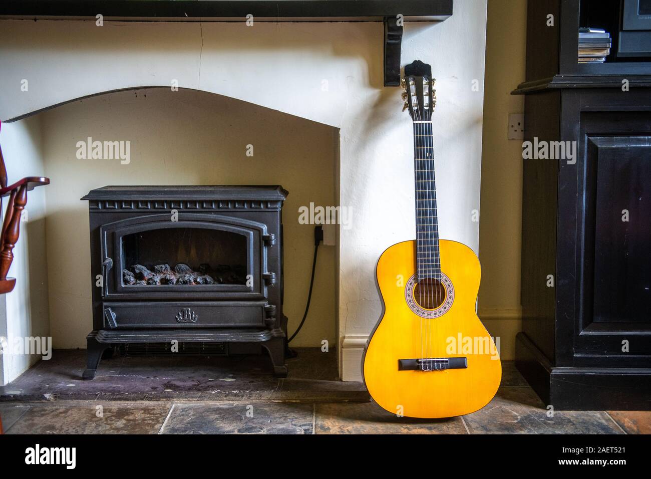 A guitar sits next to a furnace, Yorkshire, UK Stock Photo