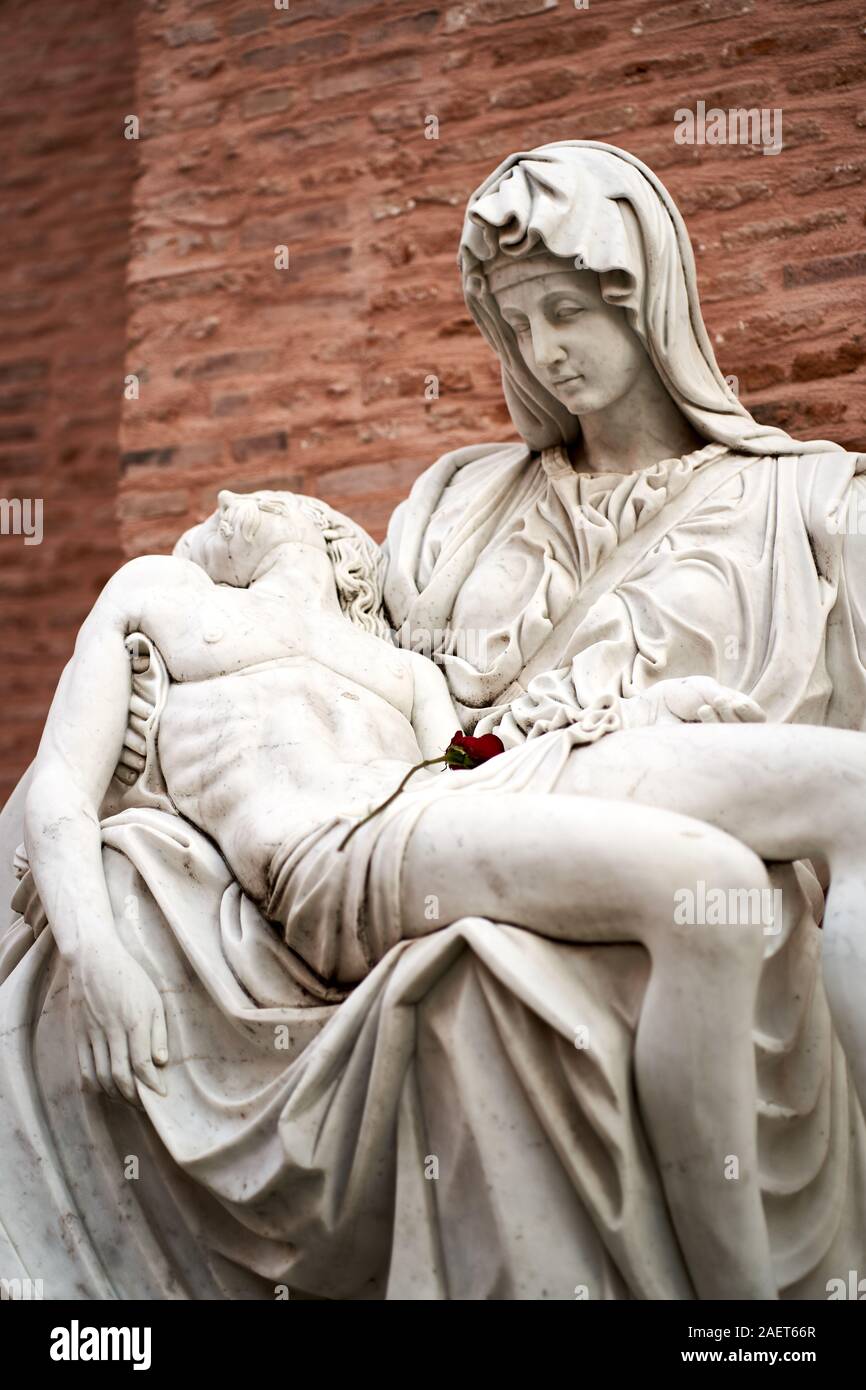 An Elaborate Memorial In Marble Featuring A Shrouded Woman Holding A Dead Man In Her Arms A