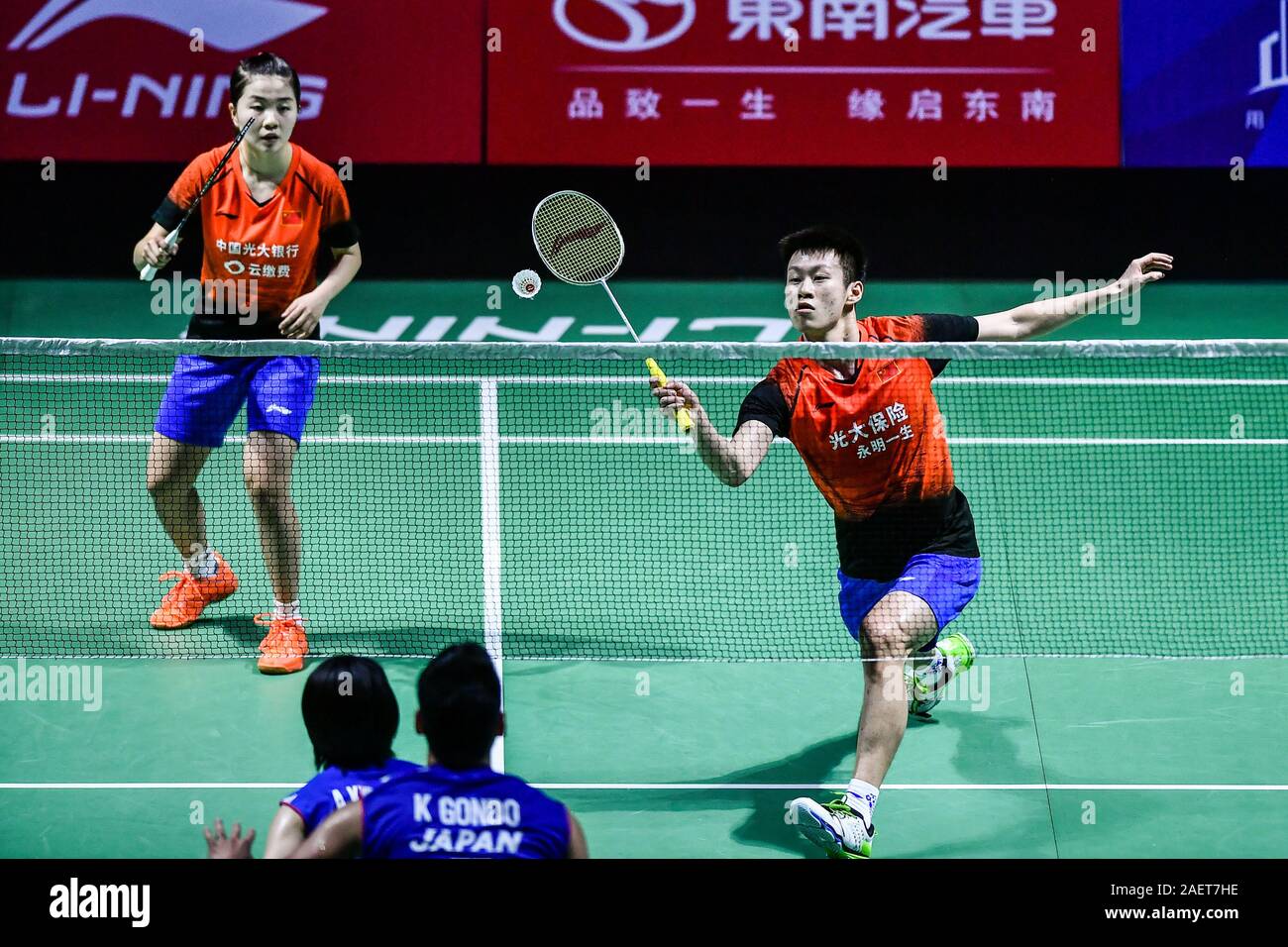 Ren Xiaoyu and Zhou Chaomin of China get the ball against Kouhei Gondou and Ayane Kurihara of Japan at the first round of mixed doubles of Fuzhou Chin Stock Photo