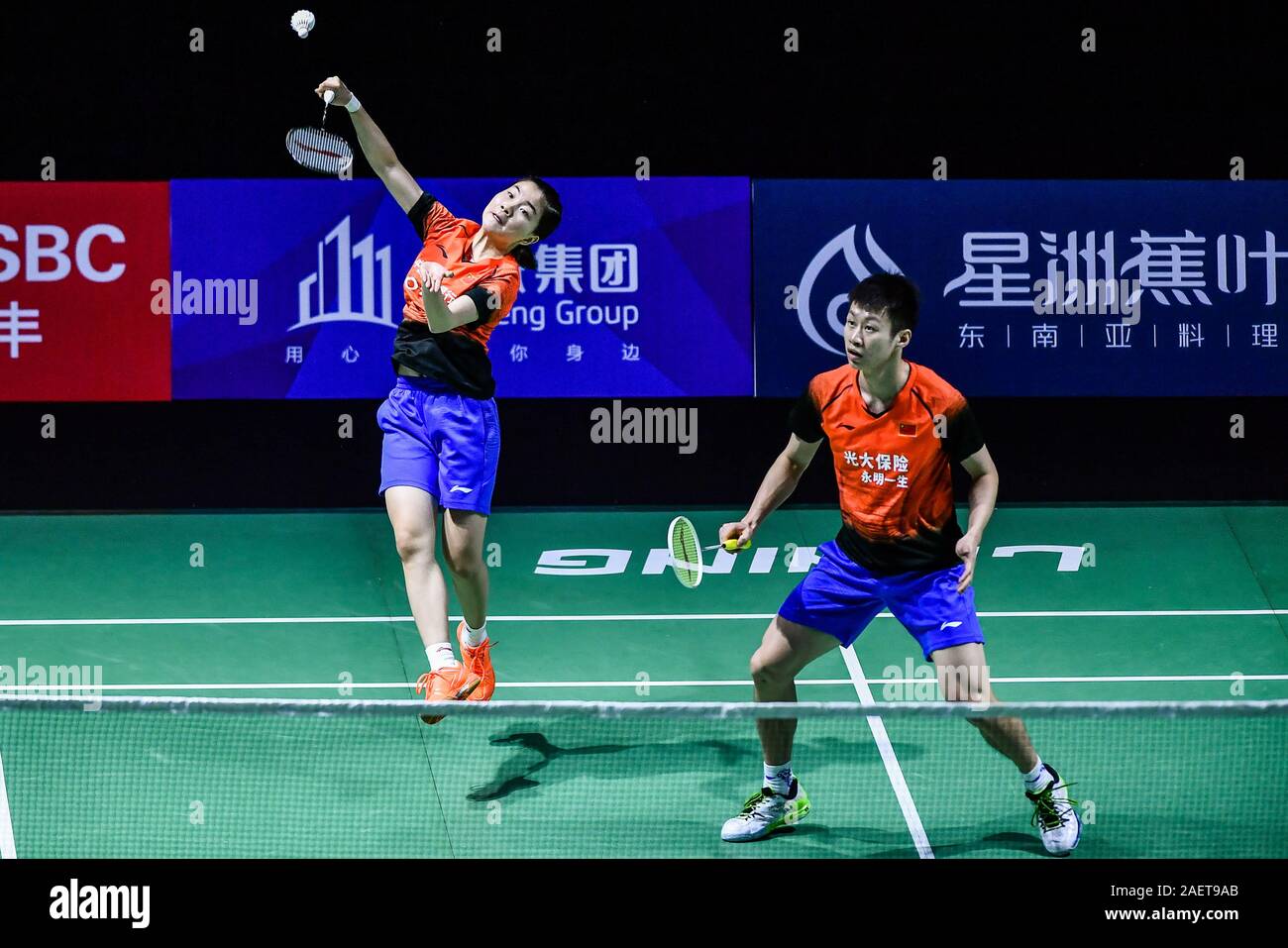 Ren Xiaoyu and Zhou Chaomin of China get the ball against Kouhei Gondou and Ayane Kurihara of Japan at the first round of mixed doubles of Fuzhou Chin Stock Photo