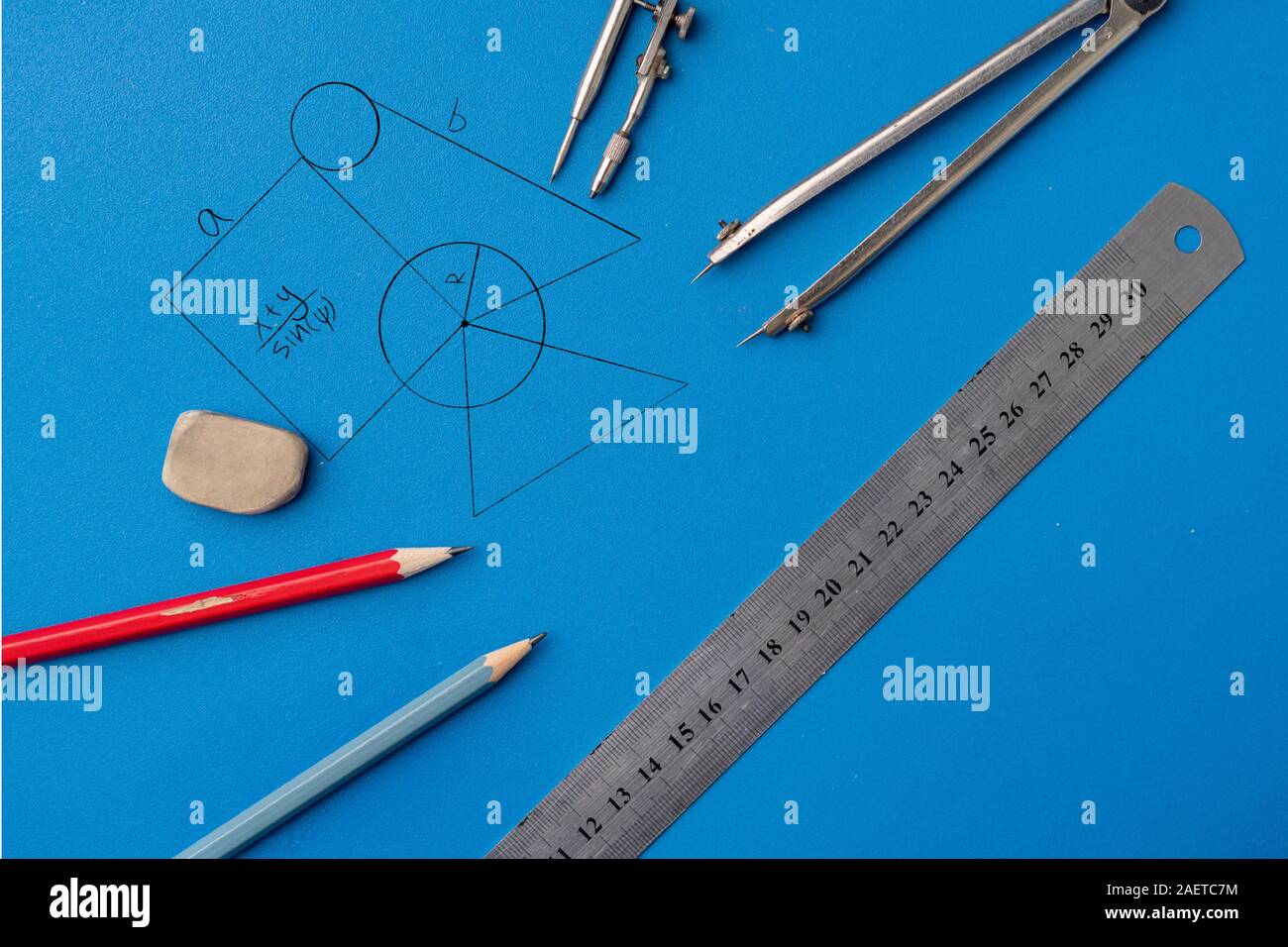 drawing plan on a color surface using the pencil, ruler, compass and ...
