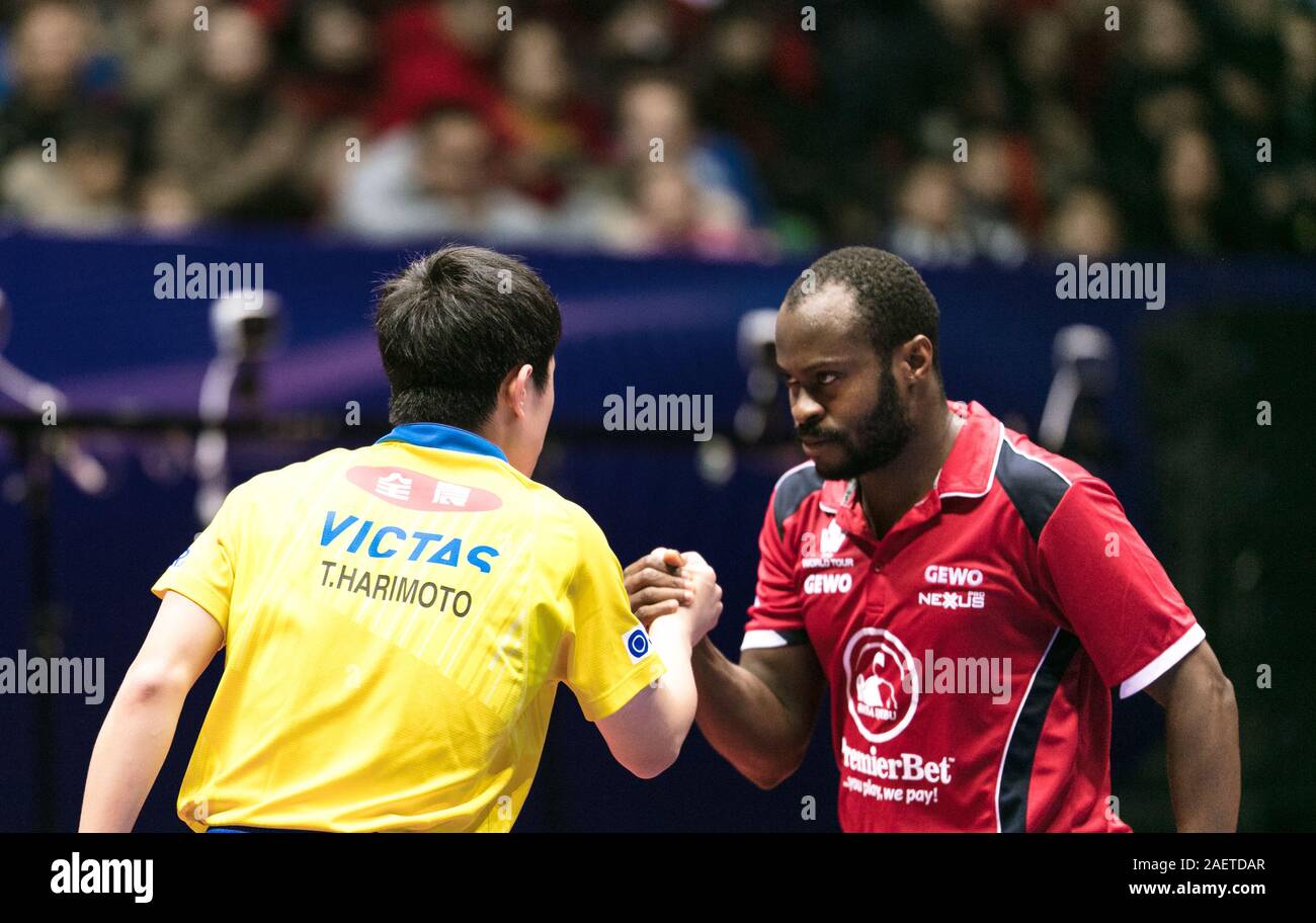 Aruna Quadri of Nigeria, right, shakes hands with Harimoto Tomokazu of