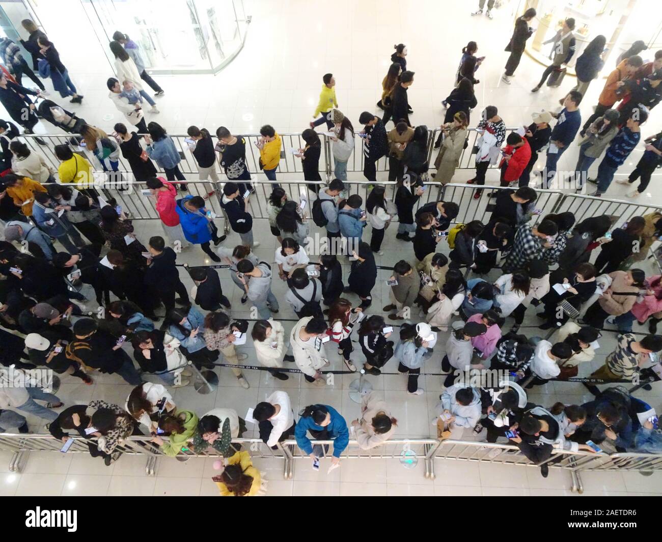 Local citizens, especially the youth, form a long line to buy milk tea