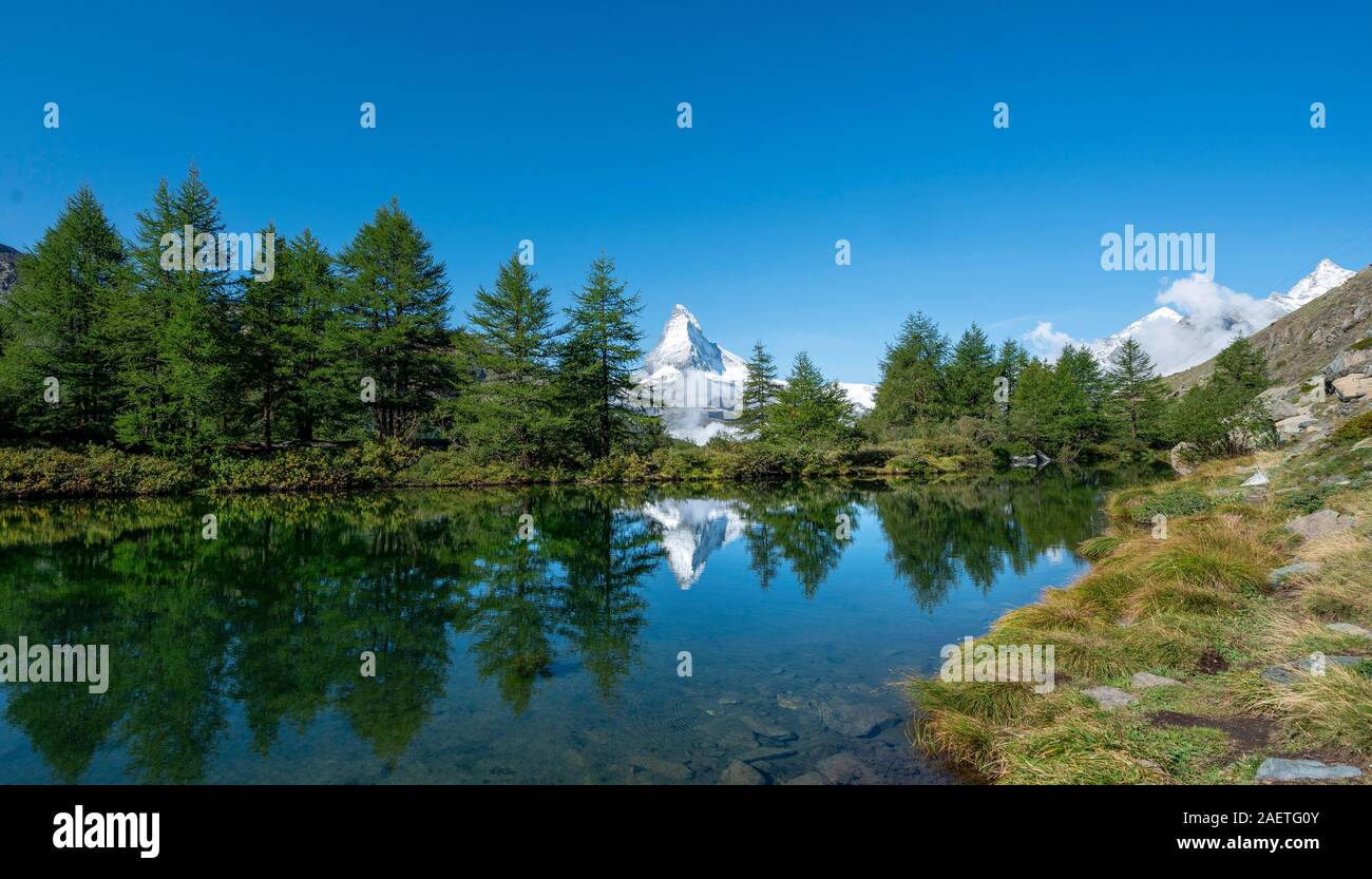 Snow-covered Matterhorn reflected in the lake, Lake Grindij, Zermatt, Wallis, Switzerland Stock Photo
