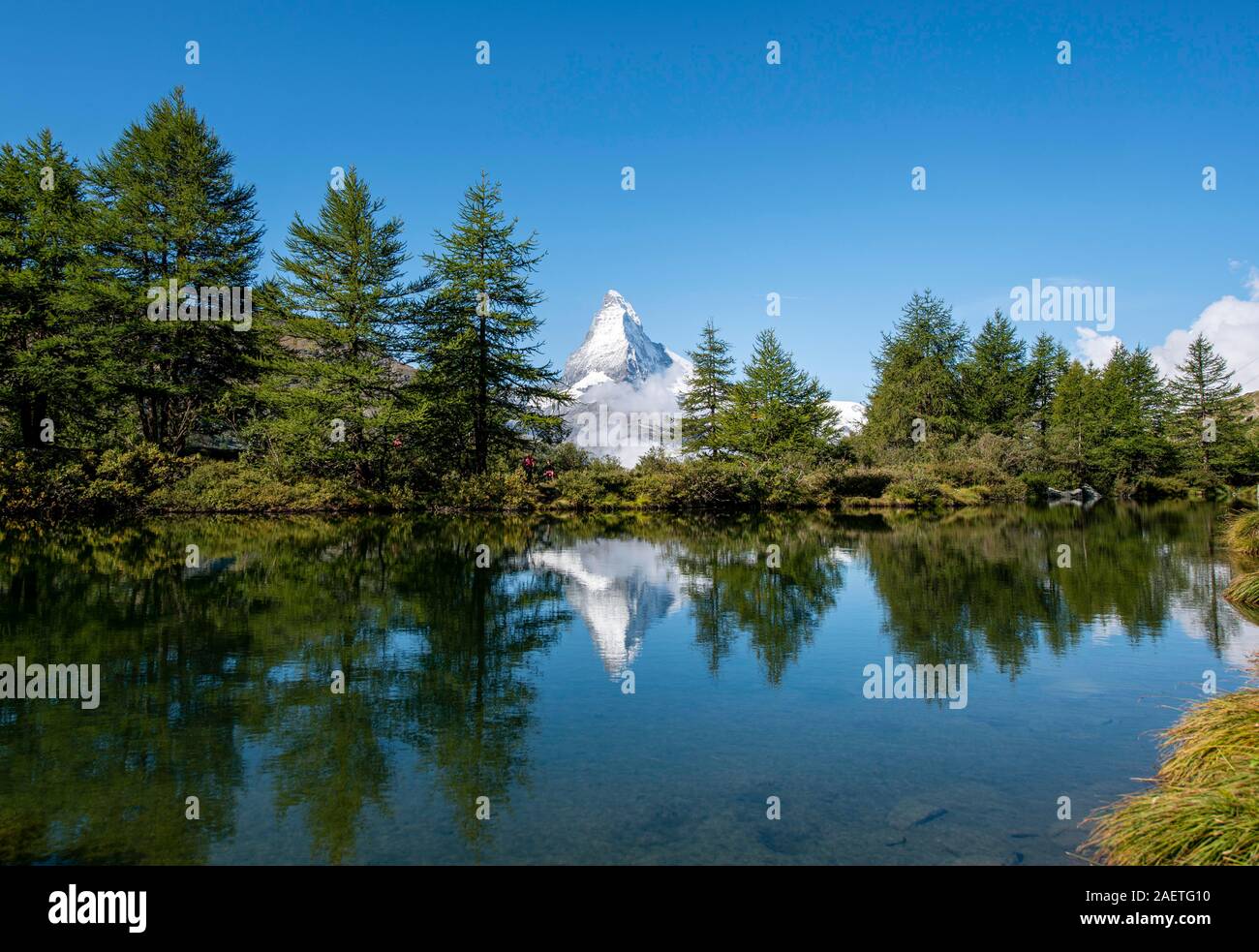 Snow-covered Matterhorn reflected in the lake, Lake Grindij, Zermatt, Wallis, Switzerland Stock Photo