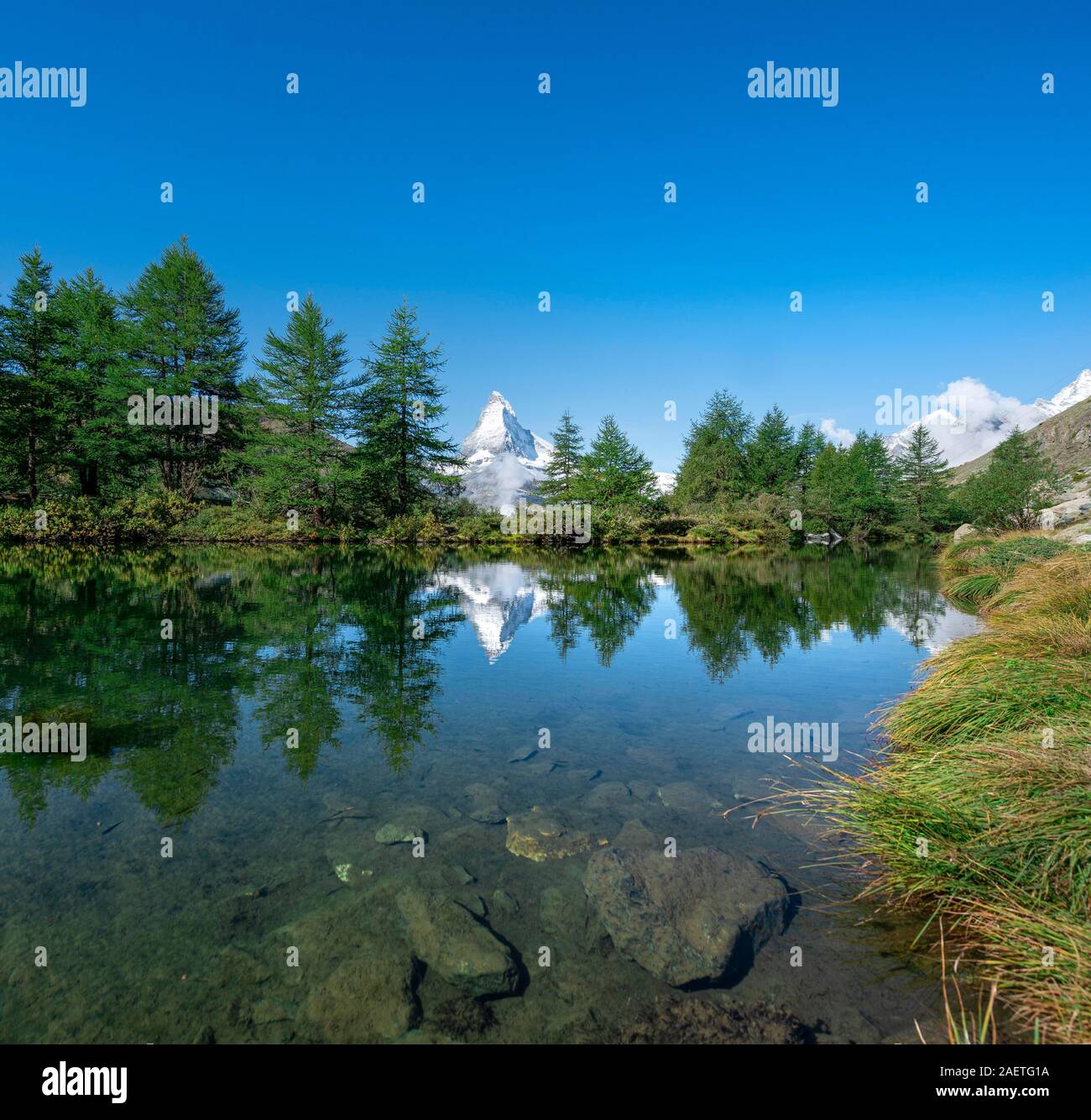 Snow-covered Matterhorn reflected in the lake, Lake Grindij, Zermatt, Wallis, Switzerland Stock Photo