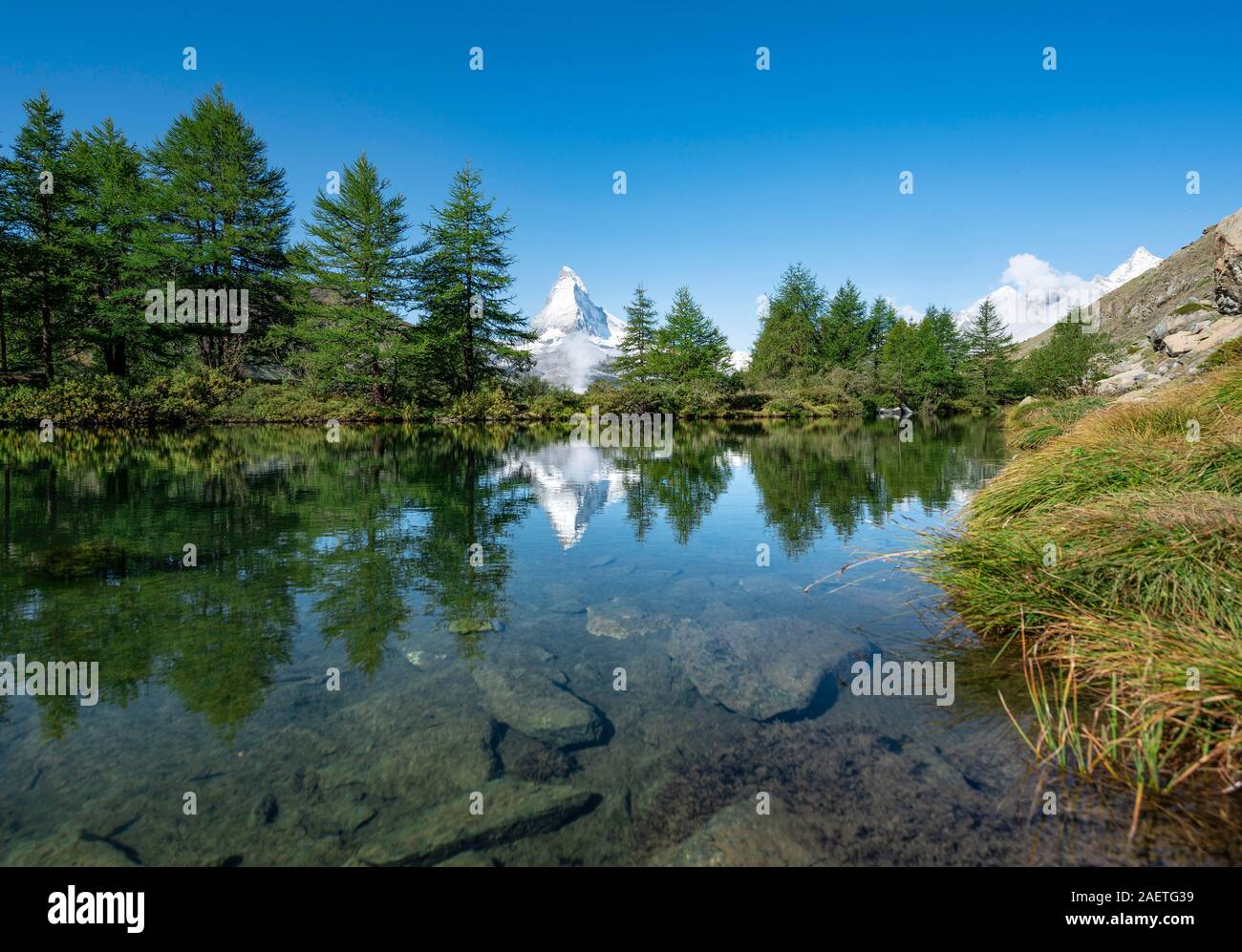Snow-covered Matterhorn reflected in the lake, Lake Grindij, Zermatt, Wallis, Switzerland Stock Photo