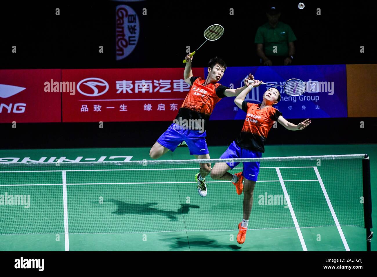 Ren Xiaoyu and Zhou Chaomin of China get the ball against Kouhei Gondou and Ayane Kurihara of Japan at the first round of mixed doubles of Fuzhou Chin Stock Photo