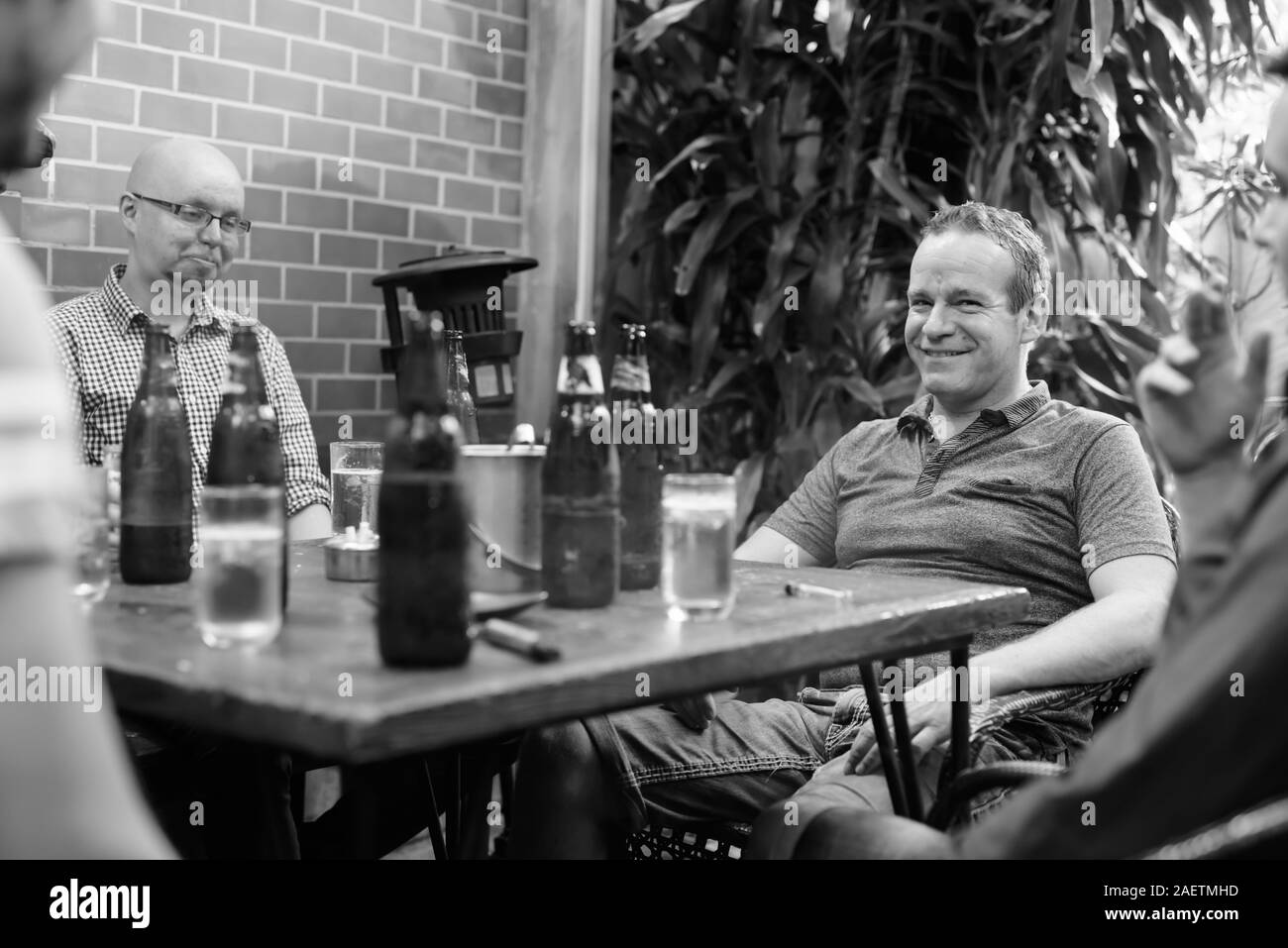 Group Of Men Hanging Out And Relaxing Together In The Backyard Stock 