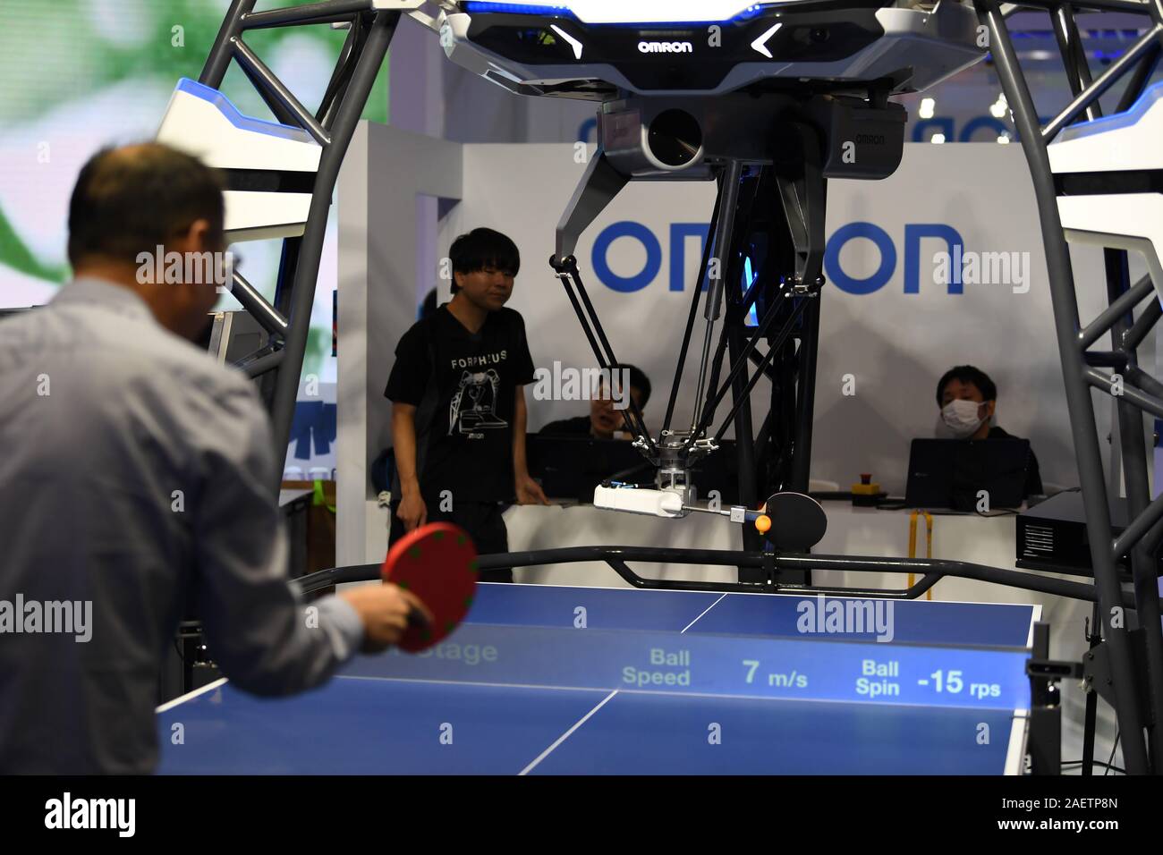 A person plays ping-pong with Forpheus, the ping-pong robot designed by  Omron at the second China International Import Expo (CIIE) in Shanghai,  China Stock Photo - Alamy
