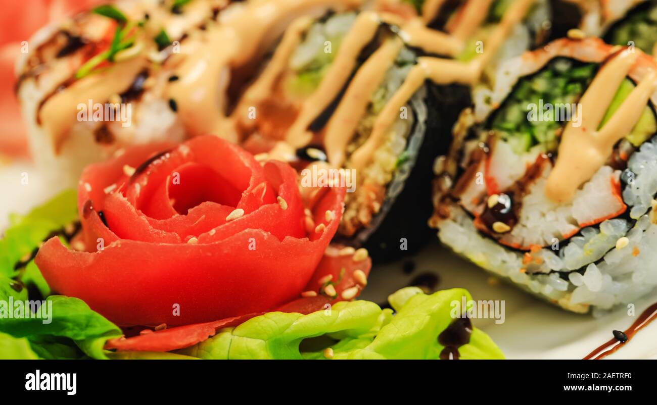 Red Carved Tomato On Background Of Sushi In Sous Restaurant