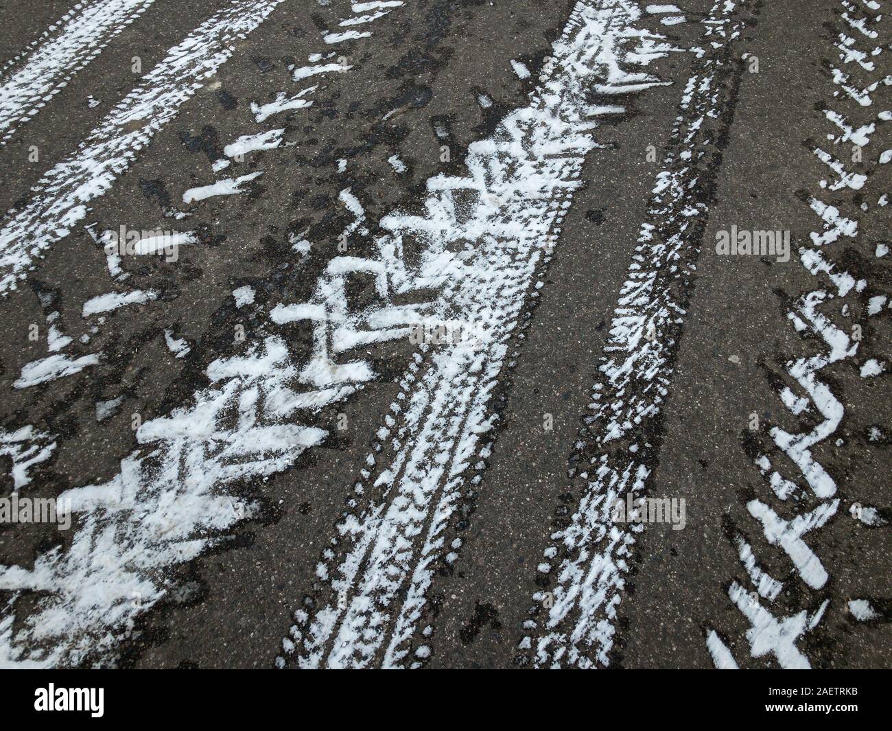 snowy asphalt road covered with tyre tracks in winter day Stock Photo ...