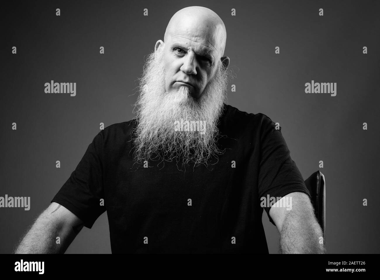 Mature bald man with long white beard in black and white Stock Photo
