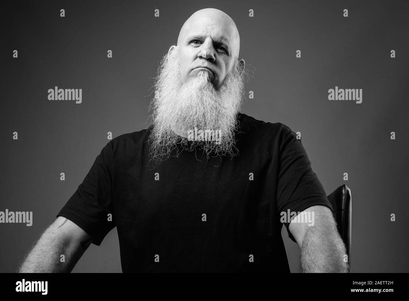 Mature bald man with long white beard in black and white Stock Photo