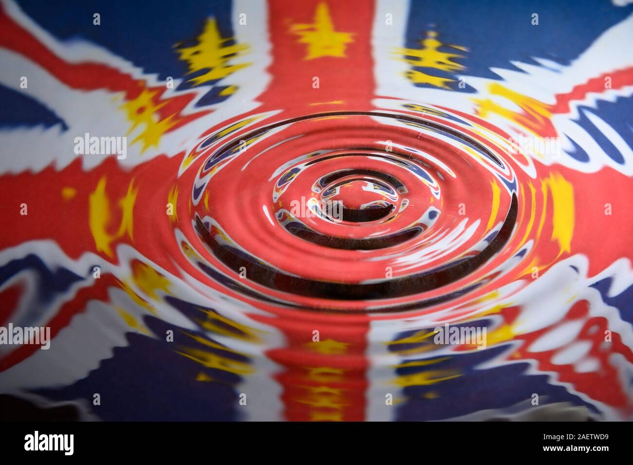 UK Union Jack with the Stars of the European Union reflected in the ripples of a water splash. Abstract Brexit background. Stock Photo