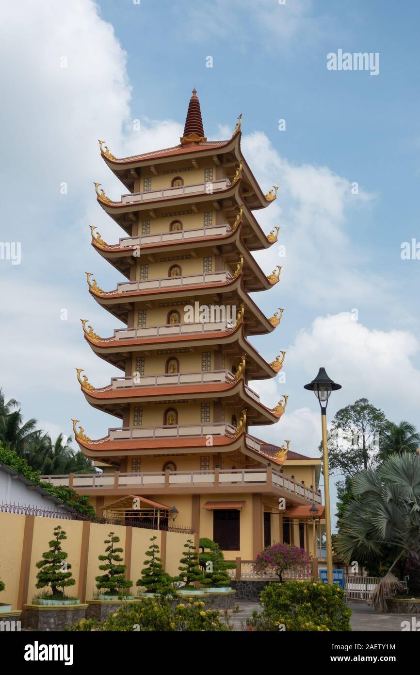 A tall tower with many stories and roofs at Vinh Trang pagoda near My Tho, Vietnam Stock Photo