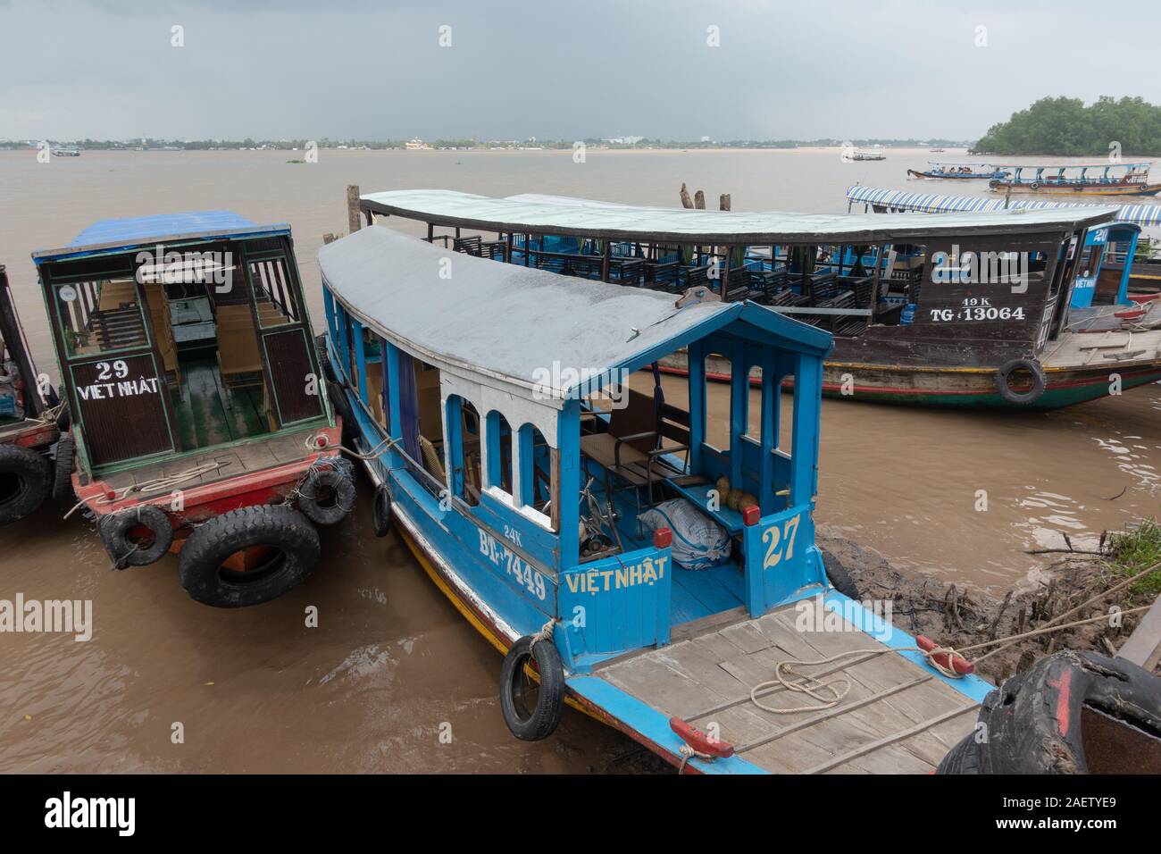 River boats line up at the dock in the Mekong Delta of southern Vietnam ...