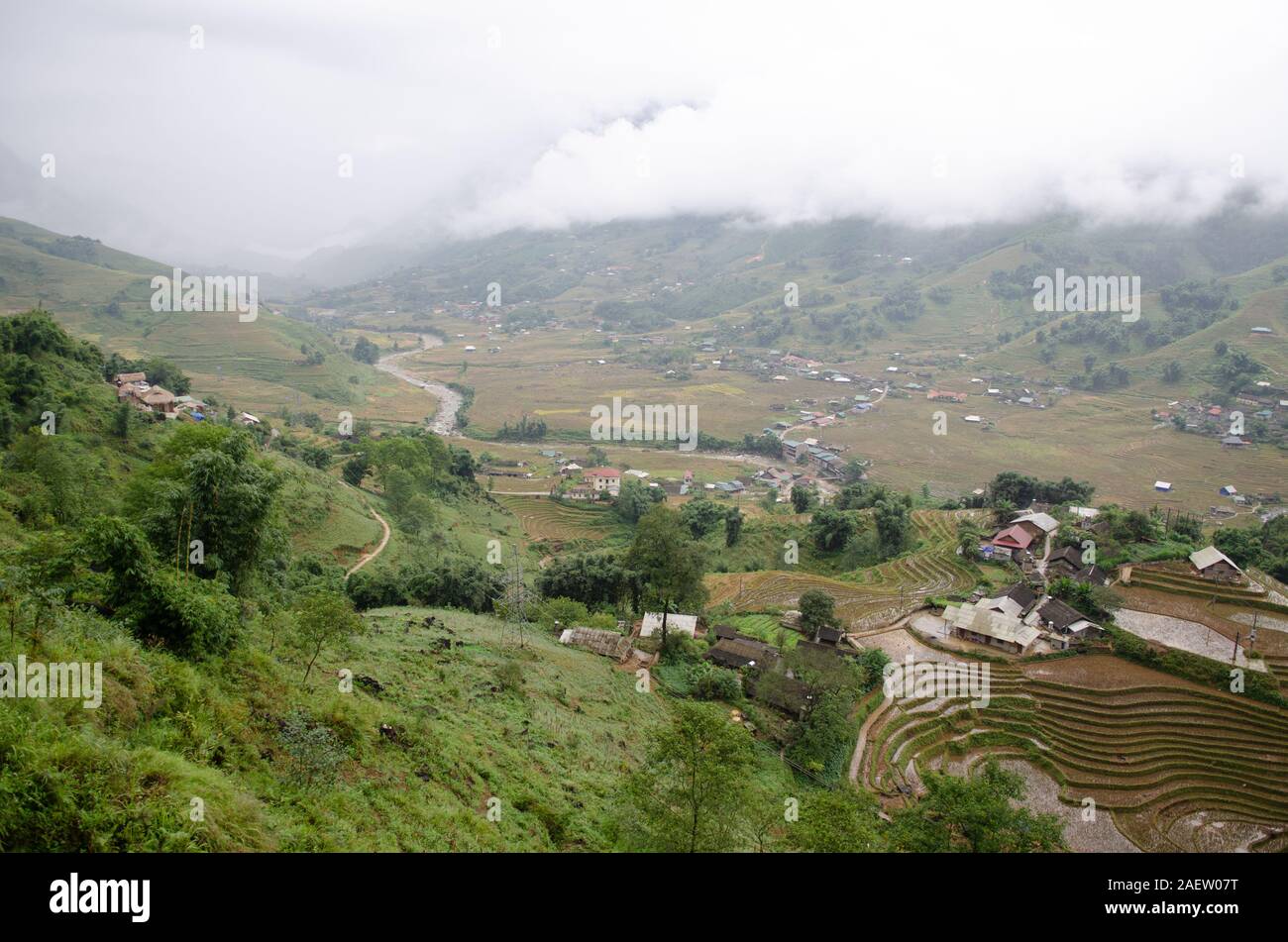 A landscape view of a valley with rice terraces and homes in Sapa, Lao Cai, Vietnam Stock Photo