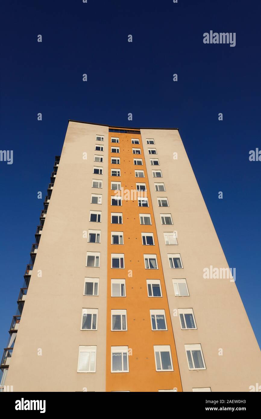 Low angle view of a high-rise mulistory residential building against a clear dark blue sky. Stock Photo