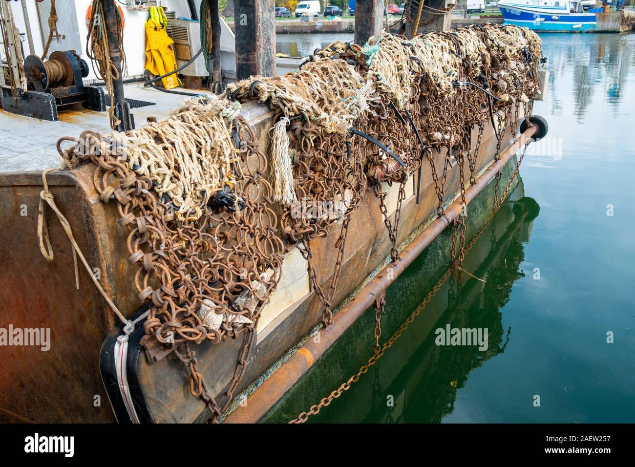 The rear side of a fishing boat in the harbor, showing the nets and