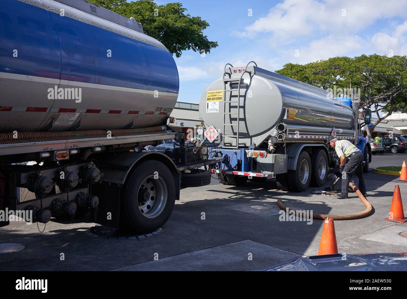 A tanker truck driver delivers gasoline to a gas station in KailuaKona