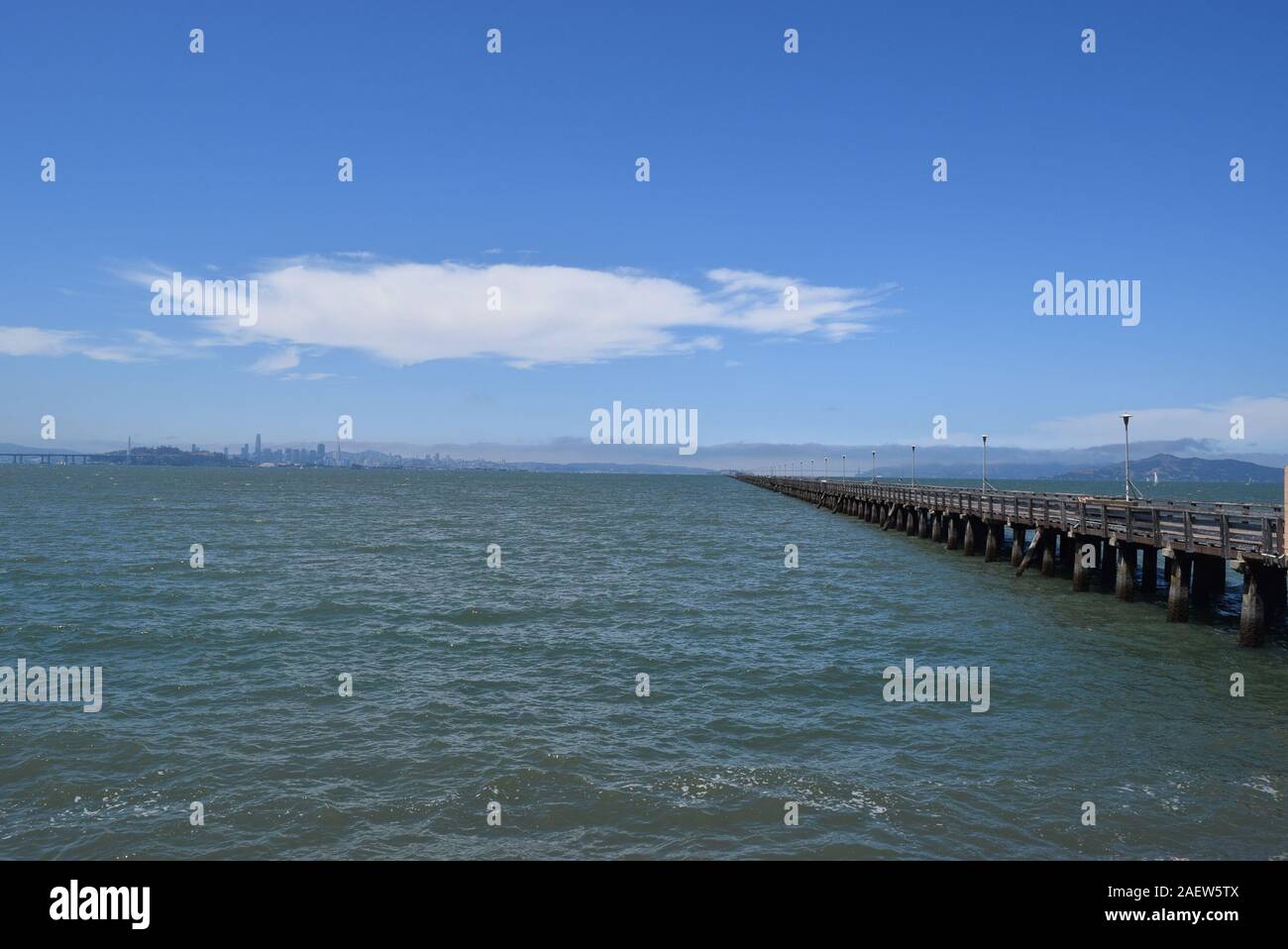 View to the Golden Gate taken from Berkeley Pier in the San Francisco Bay.  The city of San Francisco can be seen in the distance at left. Stock Photo