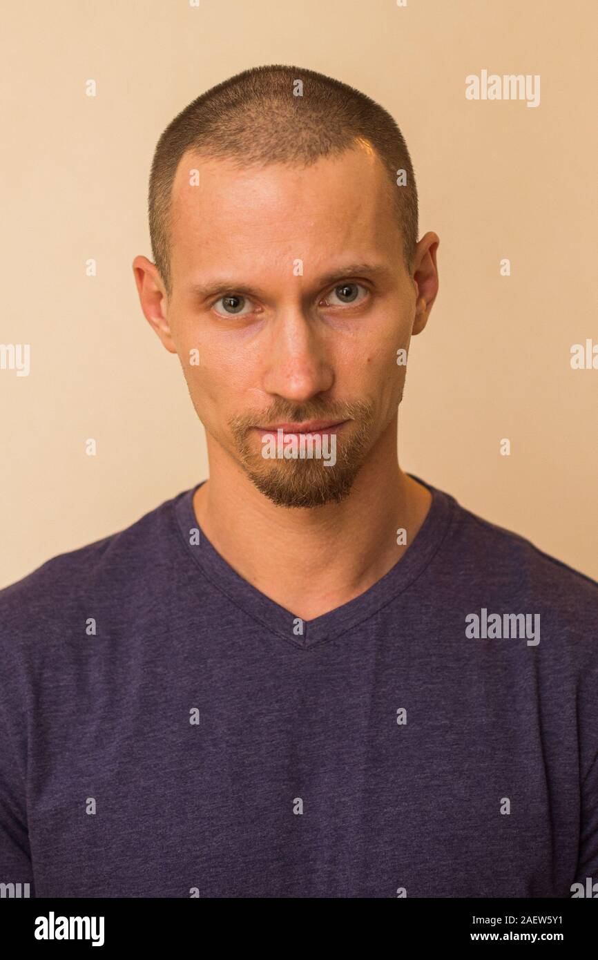 Brooding Look Man Portrait of a brooding young man in a blue or purple photoball against ...