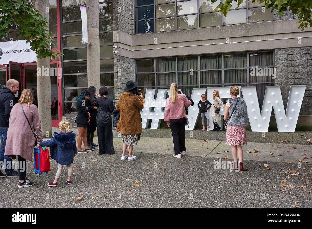 Kids attending the Vancouver Kids Fashion Week take photos with the hashtag VFW sign in Vancouver, BC, Canada, on Sunday, Oct 13, 2019. Stock Photo