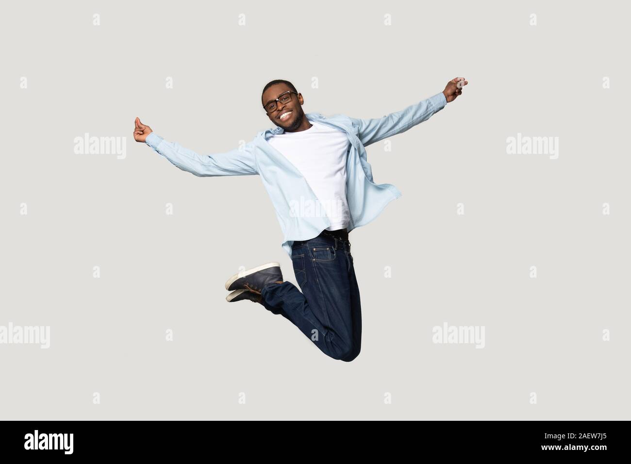 Full length overjoyed millennial african american man jumping. Stock Photo