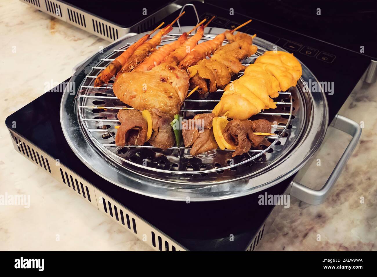 Barbecue grill In the electric stove. cooking fried food on a modern electronic  grill Stock Photo - Alamy