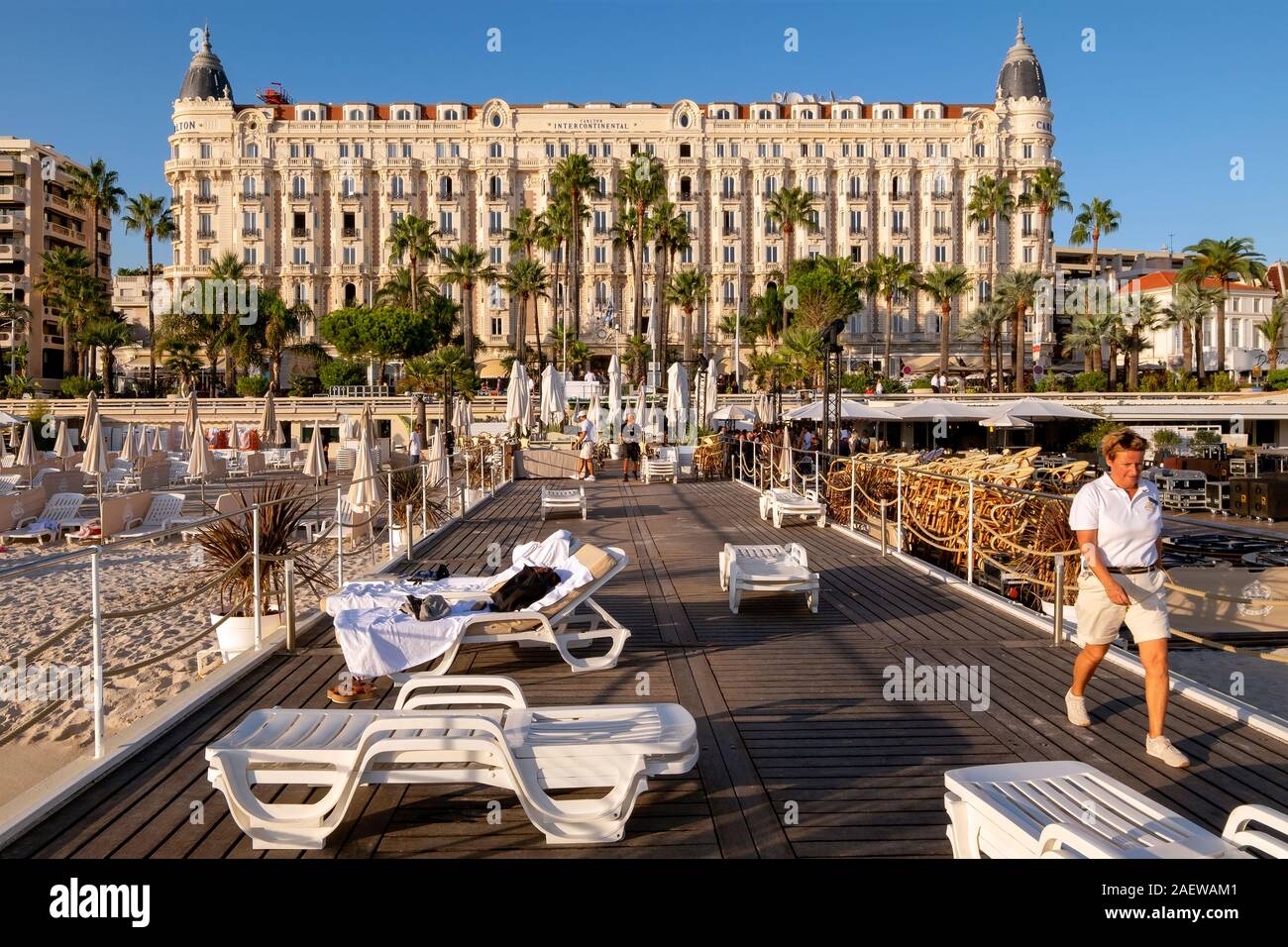 Hotel InterContinental Carlton - staff member collecting sunbeds, Cannes, Provence, France, Europe Stock Photo