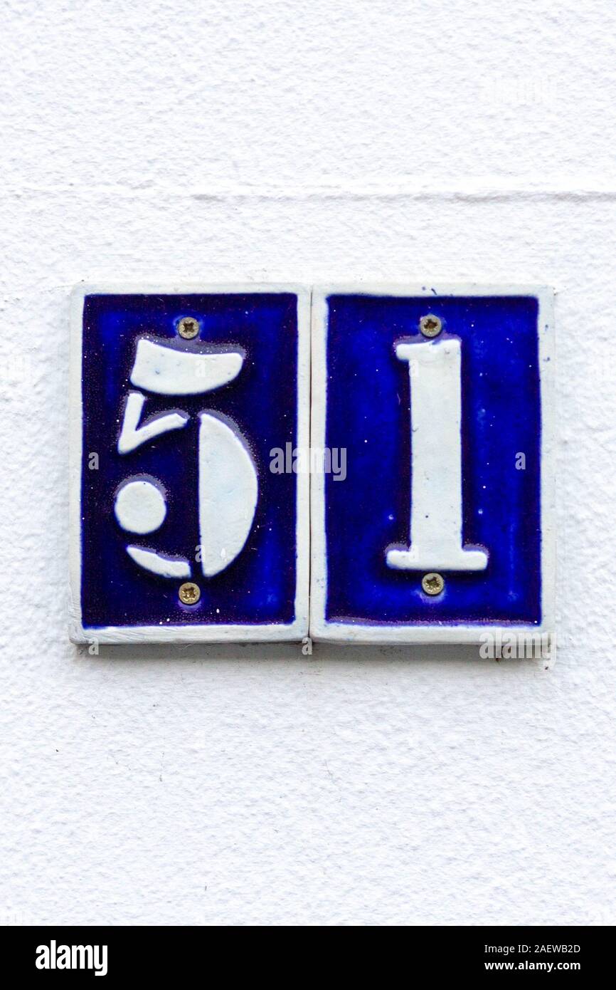House number 51 in white on blue tiles Stock Photo