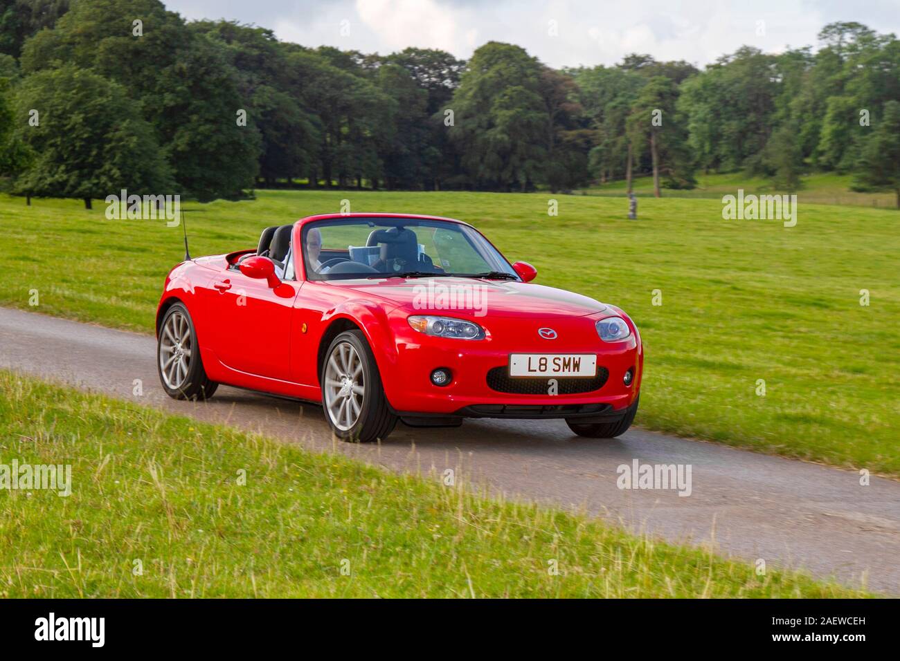 2007 red Mazda Mx5 sport; Classic cars, historics, cherished, old timers, collectable restored vintage veteran, vehicles of yesteryear sportscars arriving for the Mark Woodward motoring event at Leighton Hall, Carnforth, UK Stock Photo