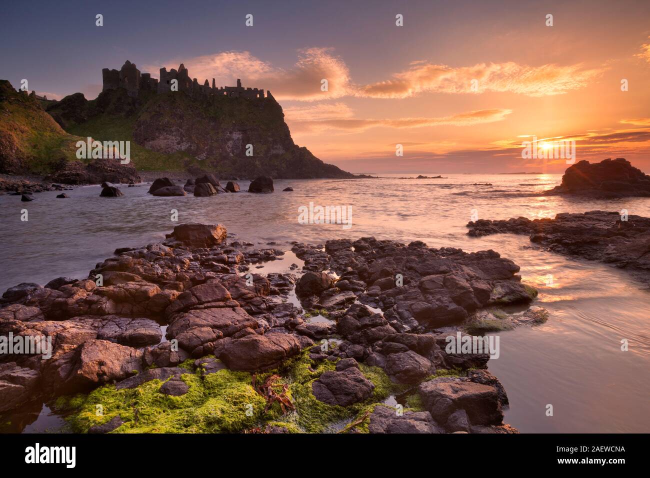 The ruins of the Dunluce Castle on the Causeway Coast of Northern Ireland. Photographed at sunset. Stock Photo